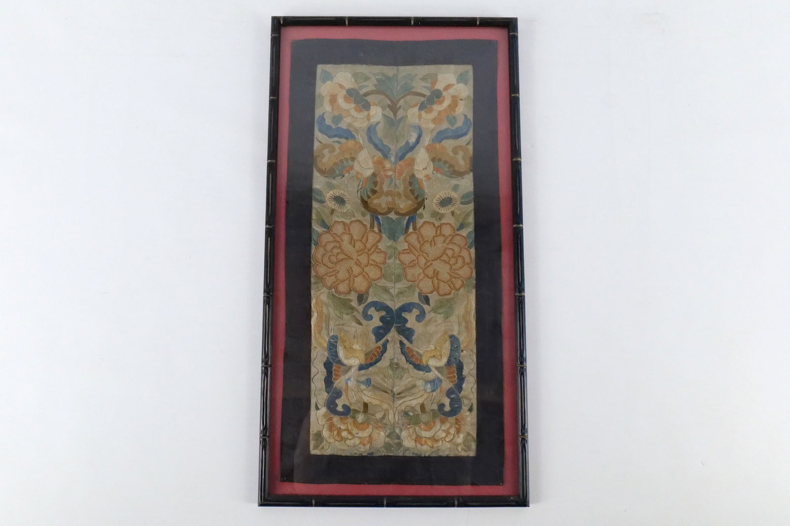 Framed Chinese Silk Embroidery: Framed Chinese Silk Embroidery. Peonies and Butterfly Motif. "Love and Happiness". Comes in bamboo style frame. Some dark spots on fabric. Measures 23" tall x 12" wide. All invoices must be paid withi