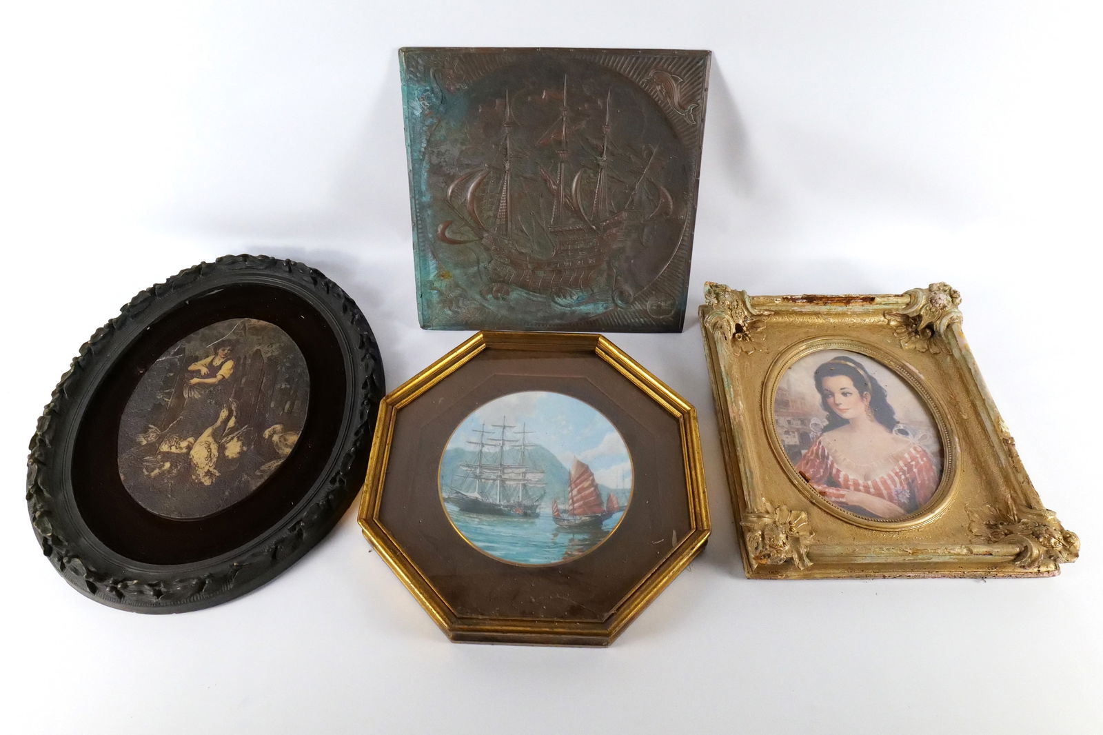 Group lot of (4) Pieces of Art.: Group lot of (4) pieces of art. Lot includes hand-hammered copper boat has tarnishing, framed plate with ship theme, print portrait of woman, and a resin plaque that has a scratch on top. Largest meas