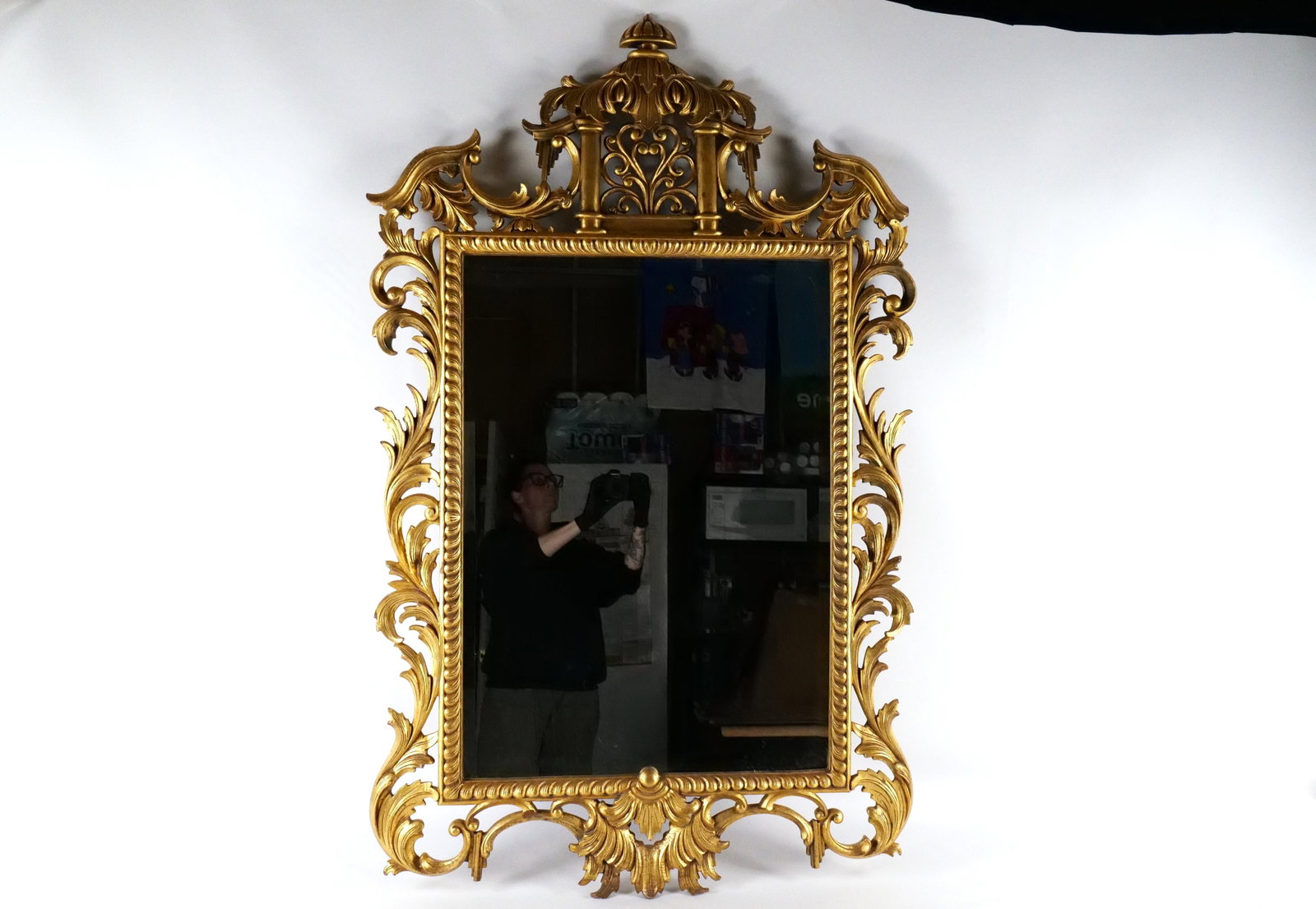 Gold Gilded Mirror: Gold Gilded Mirror with a birdcage top decoration and beveled edge. Measures 55 inches tall by 33 inches wide. All invoices must be paid within 24 hours of the sale. We offer multiple shipping options