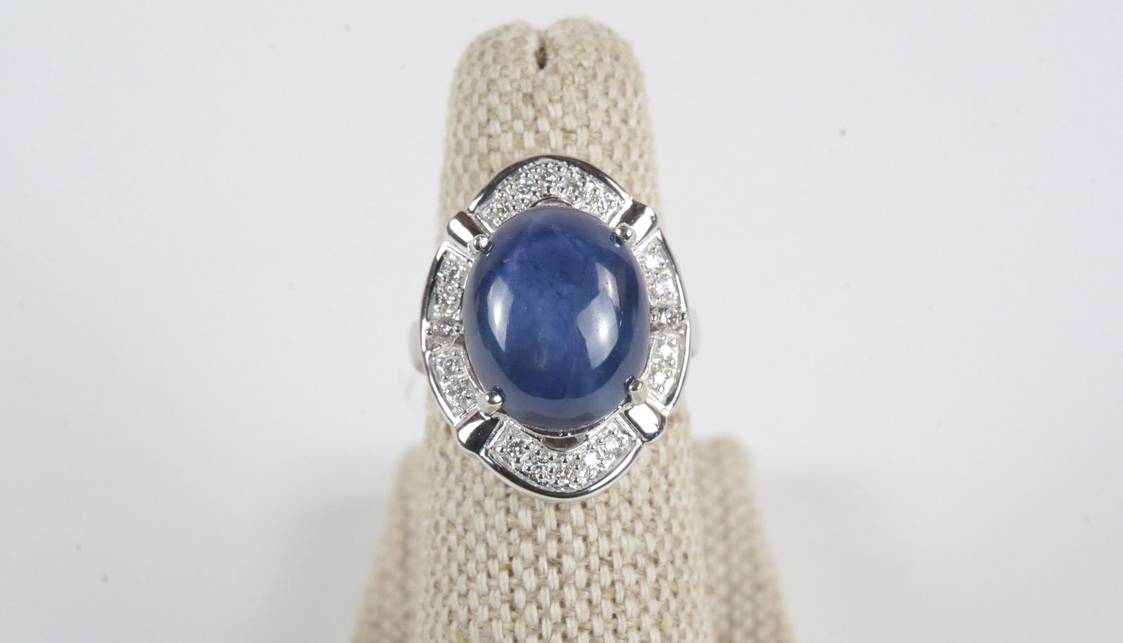 14K White Gold Blue Star Sapphire and Diamond Ring: 14K White Gold Blue Star Sapphire and Diamond Ring. Contains 1 Sapphire weighing 9.69 carats and Diamonds weighing .18 carats. Total Ring Weight is 7.60 grams. Ring Size 5. Comes with AIS Report. All