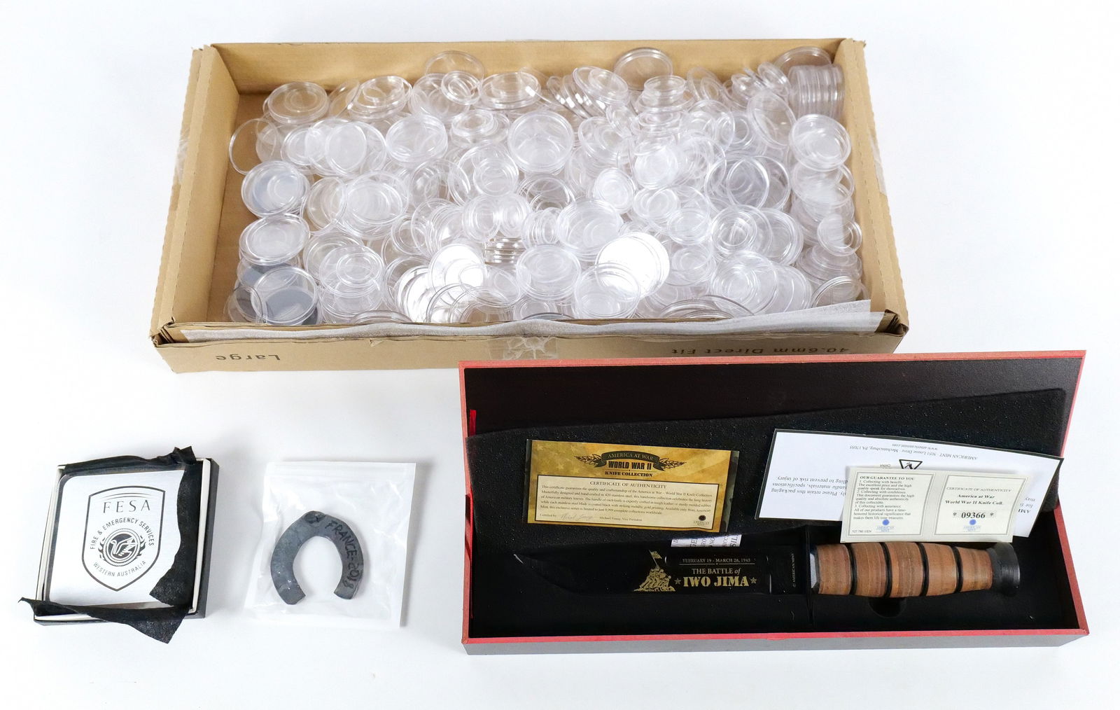 Group Misc Items: Group Misc items including a horseshoe, Silver FEMA coasters, a box of coin cases and a Battle of Iwo Jima knife in box. All invoices must be paid within 24 hours of the sale. We offer multiple shippi