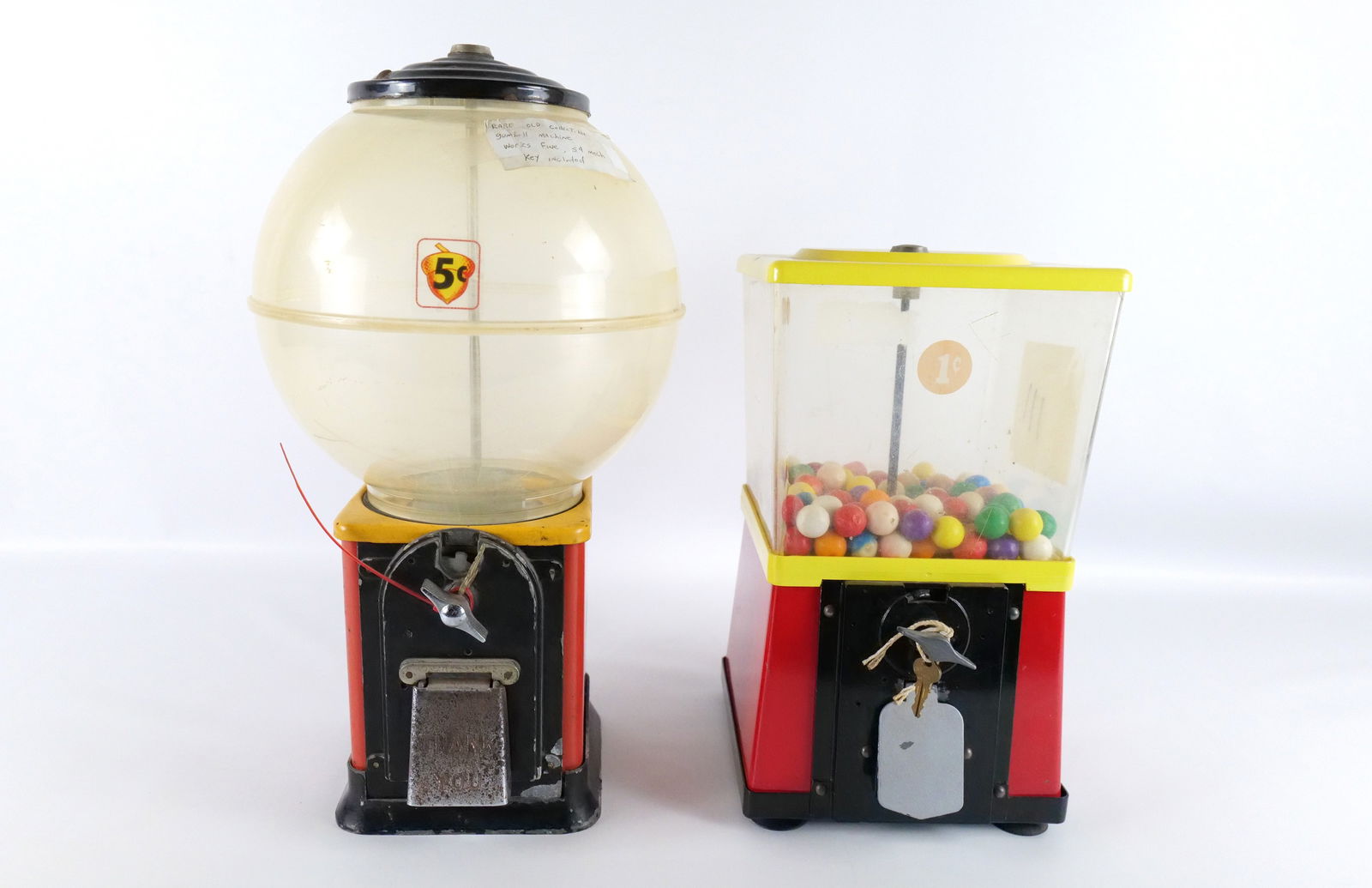 Lot of 2 Vintage Gumball Machines: Lot of 2 Vintage Gumball Machines. Including Square and Round. Both Metal Bases with Plastic Dispenser Tops. Has scratching and wear to paint and discoloration to plastic. Both have stickers on them.