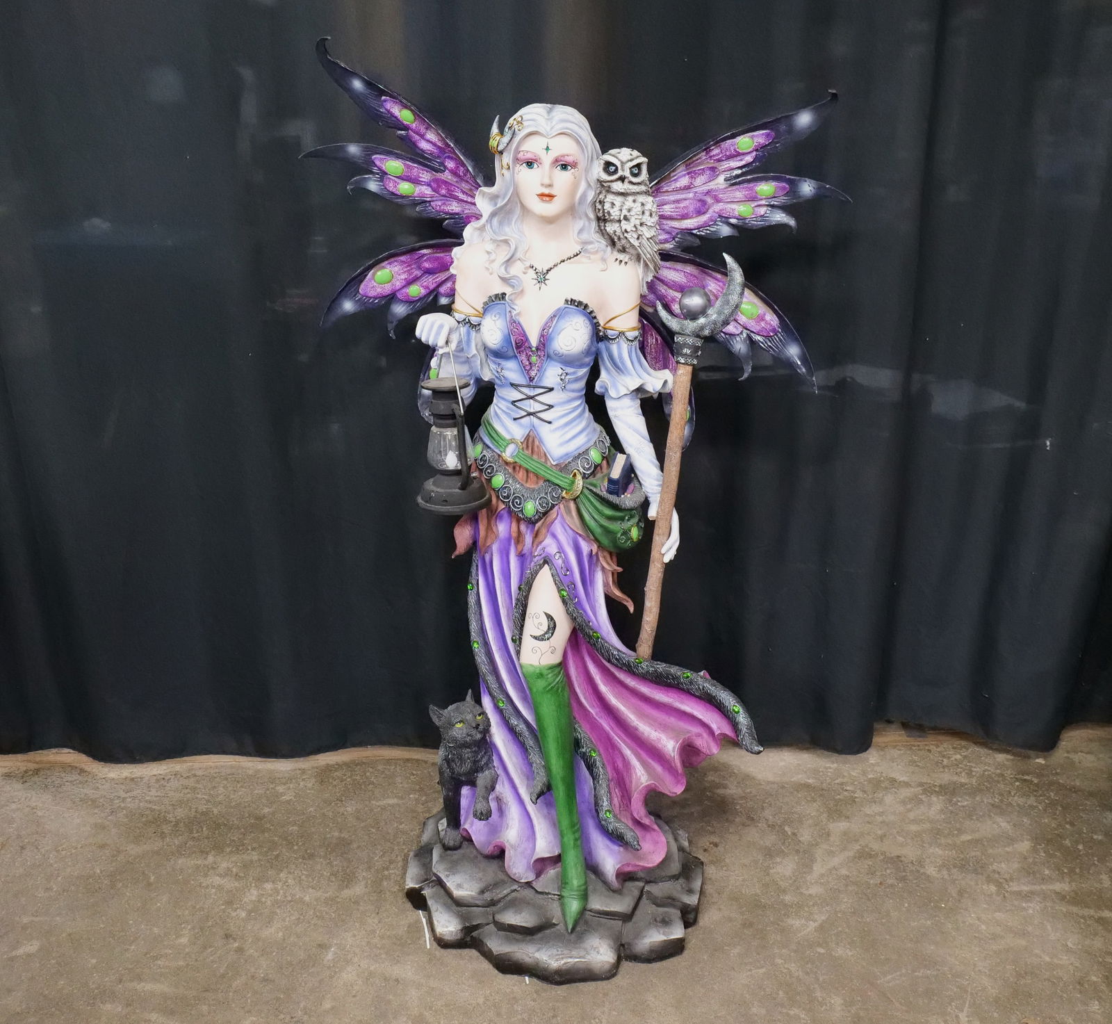 Purple Fairy Resin Decorative Sculpture: Purple Fairy Resin Decorative Sculpture. Left thumb missing. Lantern is sticky and untested. Some other minor wear/paint loss. Measures 54" tall x 33.5" wide x 19" deep. All invoices must be paid