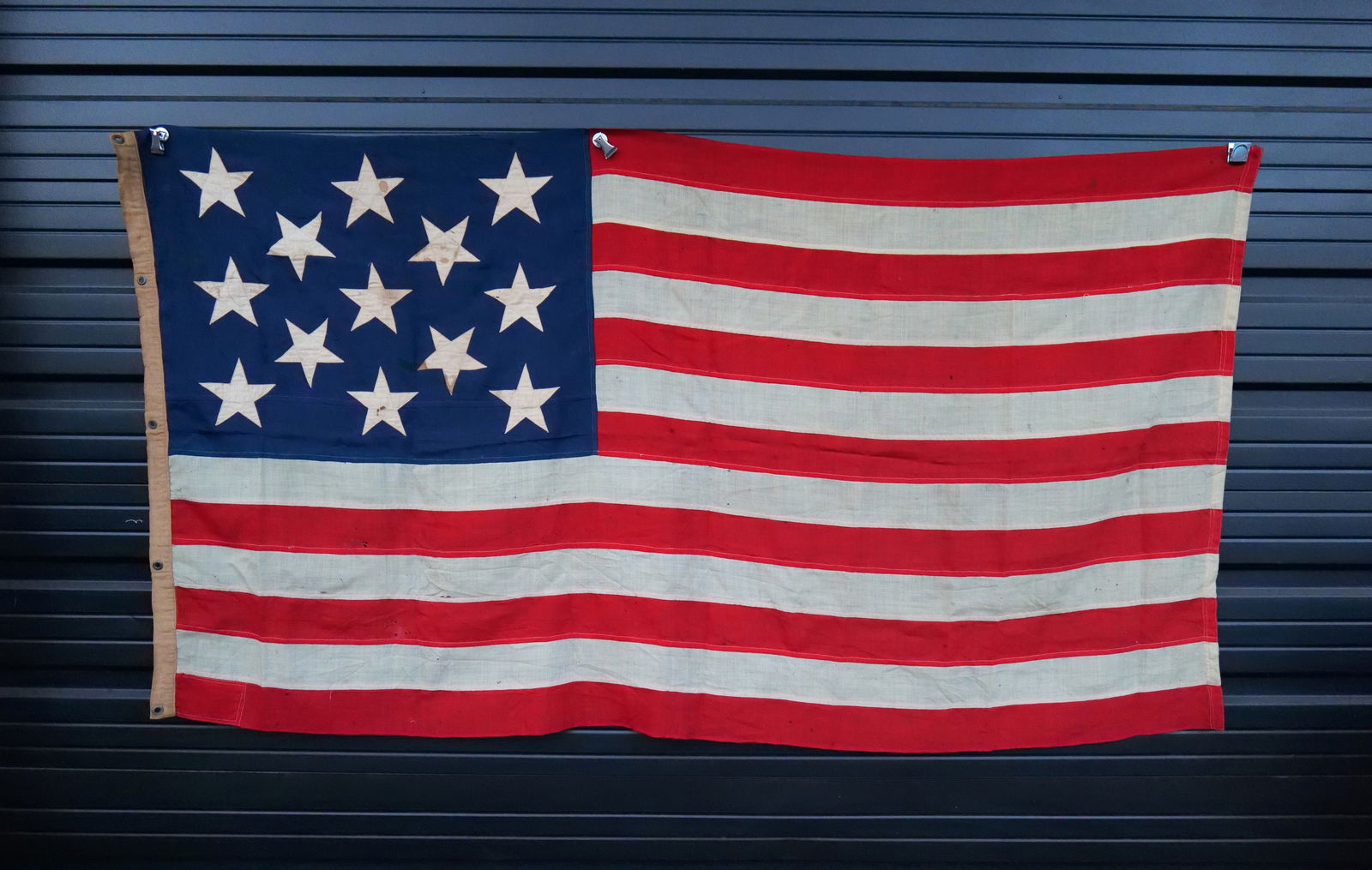 July 1909 American Flag: July 1909 American Flag - 13 Stars. Discolored with staining and has some small holes. US Ensign No. 6. Navy Yard New York. Measures approx. 4' x 6'. All invoices must be paid within 24 hours of the s