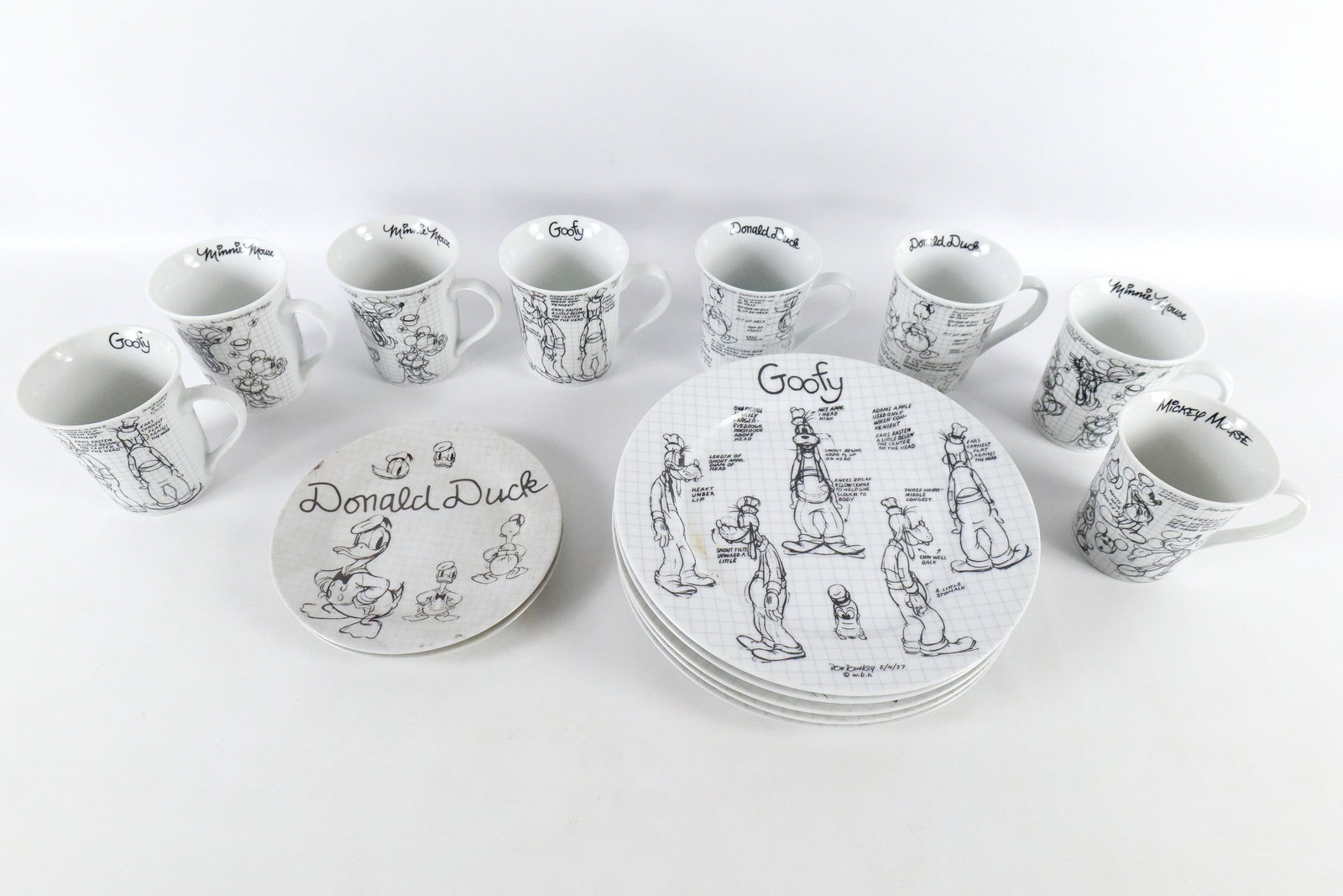 Disney Sketchbook Collection Plates and Mugs: Disney Sketchbook Collection Plates and Mugs. Including 8 Coffee Mugs - (3) Minnie, (2) Goofy, (2) Donald, and Mickey, Pluto and Donald 7.75" plates, and (5) 10.5" Dinner Plates - 1 of each of the Fab