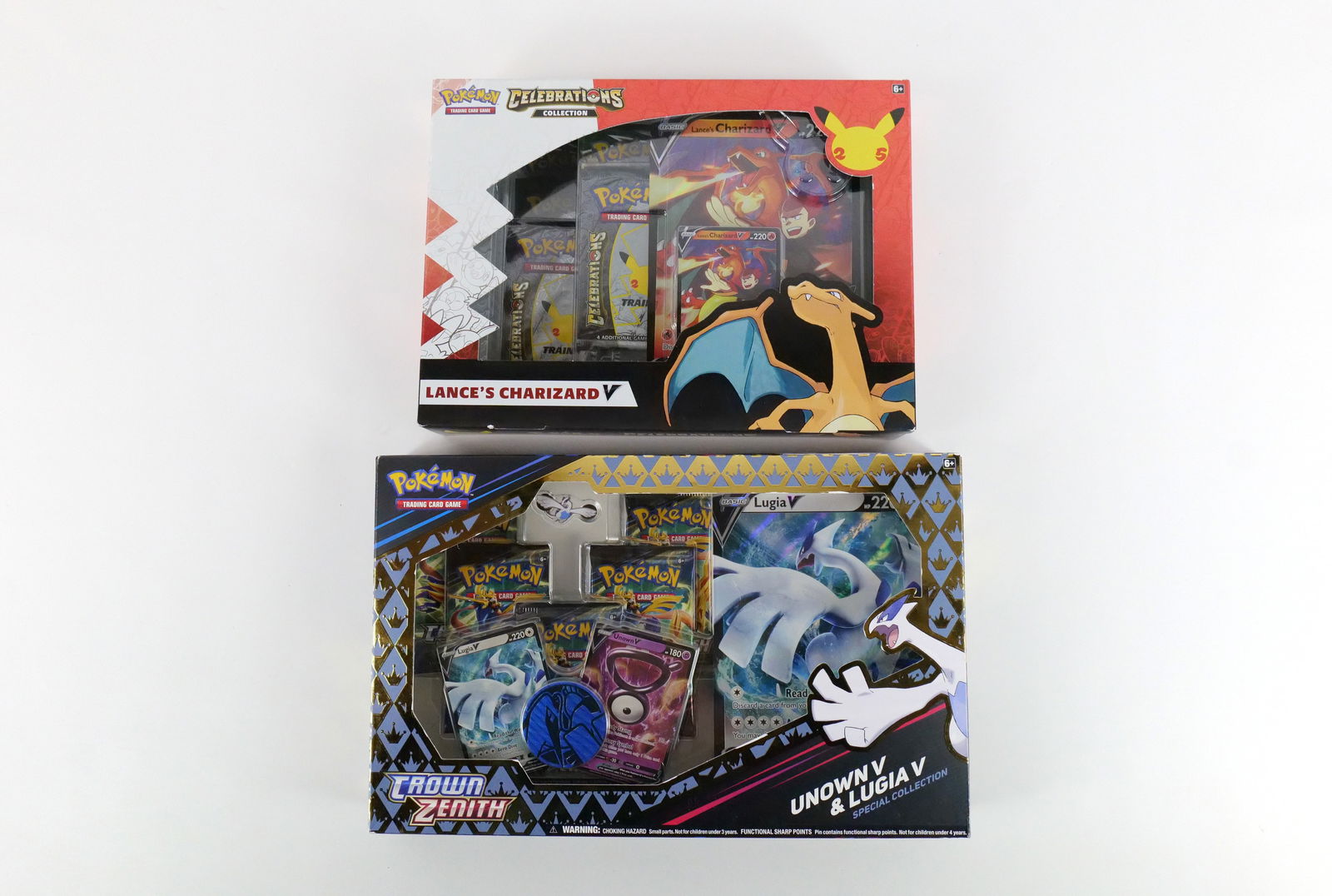 Lot of 2 Pokémon Box Sets: Lot of 2 Pokémon Box Sets. Including Celebrations Collection - Lance's Charizard and Crown Zenith Unown V Lugia V Special Collection. Both Sealed in Box. All invoices must be paid within 24 hours of