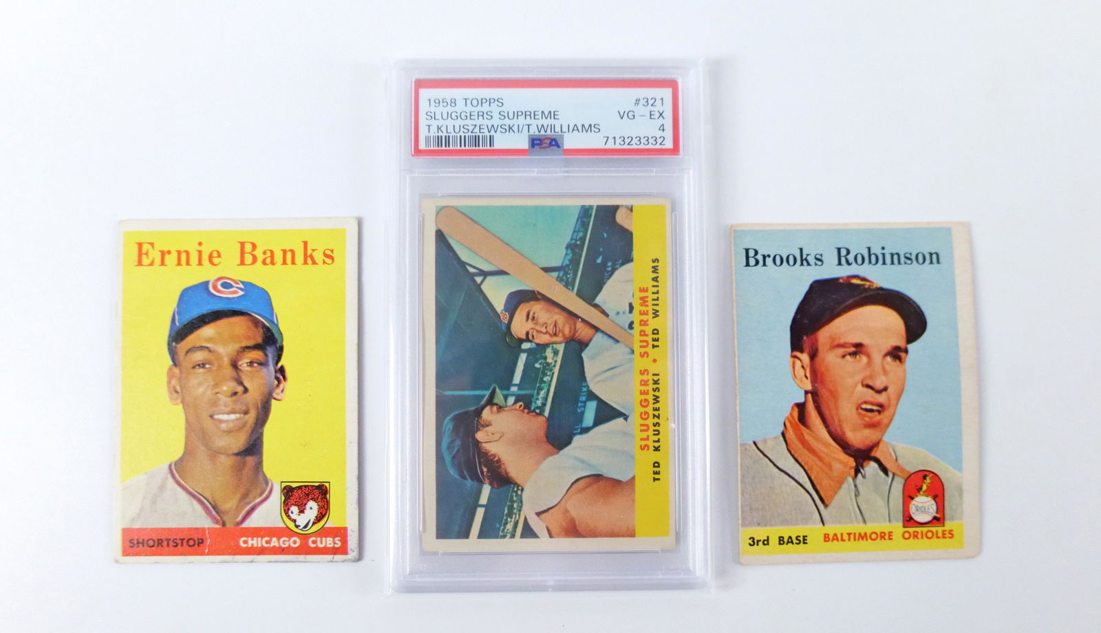 Lot of 3 Topps 1958 Baseball Cards: Lot of 3 Topps 1958 Baseball Cards. Including Brooks Robinson #307, Ernie Banks #310, and Graded Sluggers Supreme Kluszewski/Williams #321 PSA 4 VG-EX. For the ungraded cards...we are not experts in g