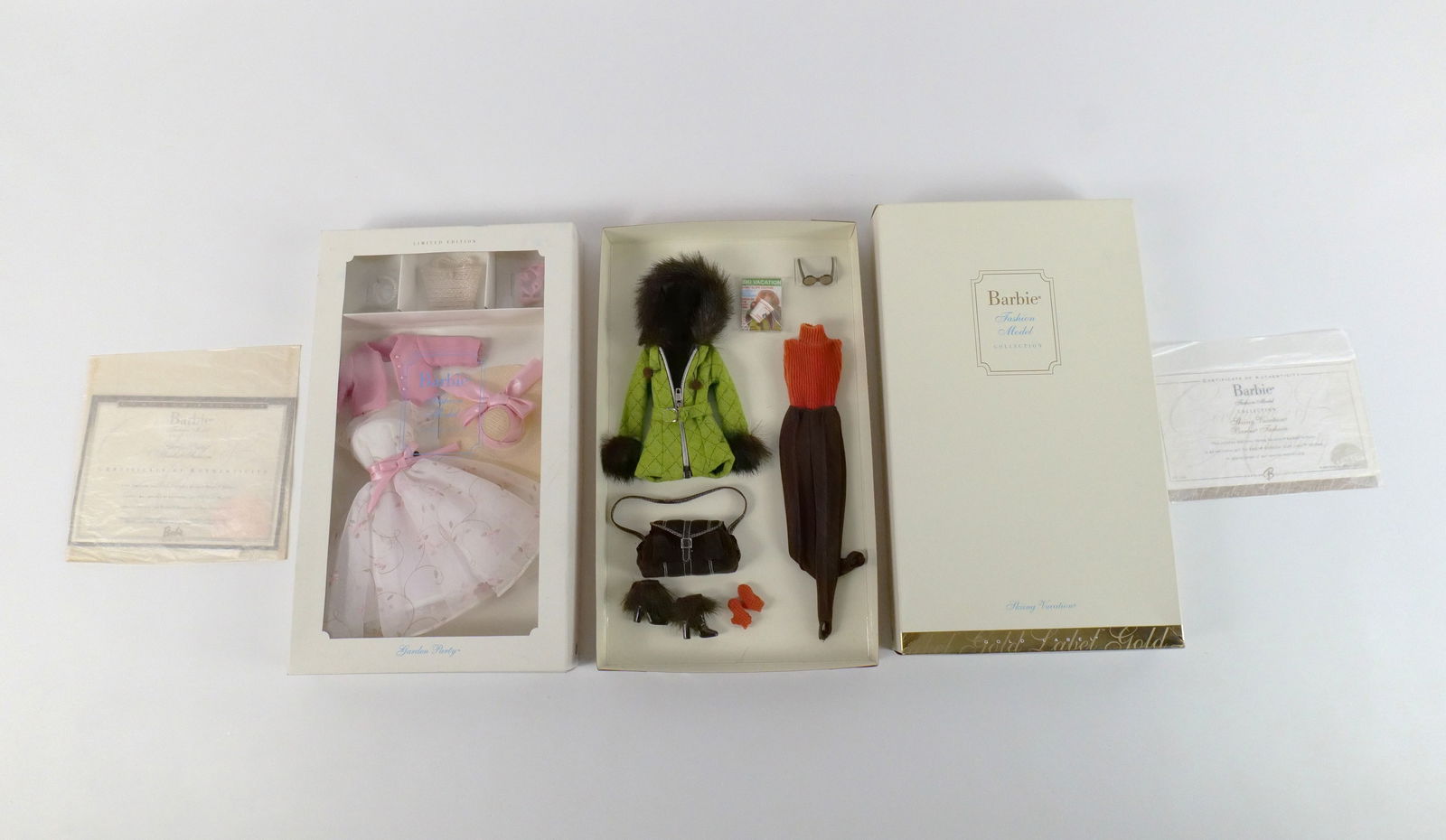 Lot of 2 Barbie Fashion Model Collection Outfits: Lot of 2 Barbie Fashion Model Collection Outfits. Including Skiing Vacation - Gold Label and Garden Party Limited Edition Outfit. Made especially for the Silkstone Barbie Doll Body - Not for use with