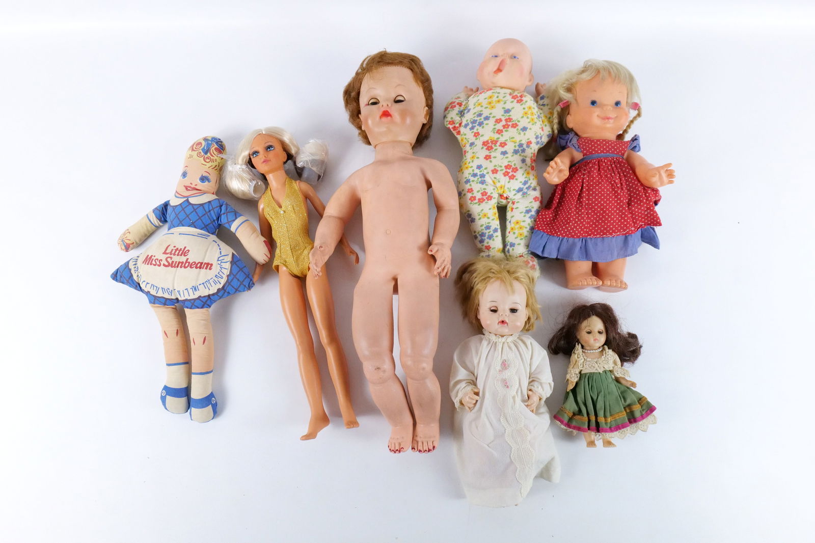 Lot of Vintage to Contemporary Dolls: Lot of Vintage to Contemporary Dolls - Plastic and Cloth. Including Yawing John Doll, Little Miss Sunbeam Cloth Doll, Ideal Tiffany Taylor, and More. Some dolls AS-IS. All invoices must be paid within