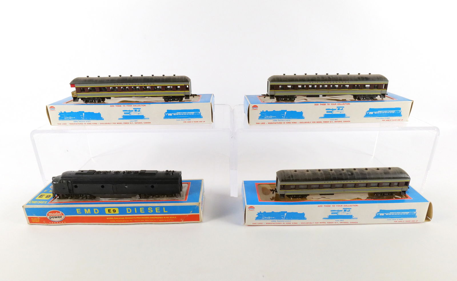 Model Power HO Gauge Passenger Car Set: Model Power HO Gauge Passenger Car Set. Including EMD E9 Diesel - 919 D - Dummy Undecorated and 3 Erie Lackawanna Passenger Cars. Used Condition. Comes with boxes. All invoices must be paid within 24