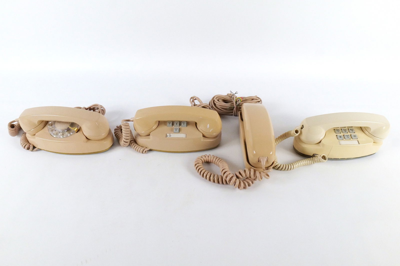Lot of 4 Vintage Western Electric Beige Telephones: Lot of 4 Vintage Western Electric Beige Telephones. Including Rotary Princess Telephone, 2x Push Button Princess Telephones, and Trimline Telephone. Some discoloration present. All invoices must be pa