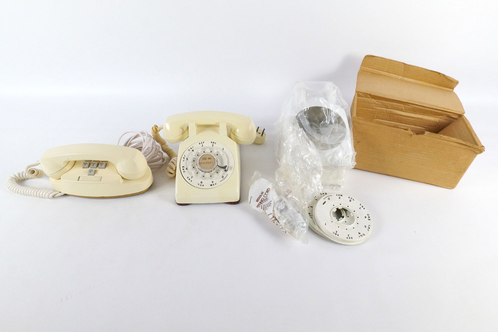 Lot of 2 Vintage Western Electric Telephones and 1 Telephone Kit: Lot of 2 Vintage Western Electric Telephones and 1 Telephone Kit. Including White Telephone Kit - Cover and Cord in original box, Cream Colored Rotary Desk Phone, and Push Button Cream Colored Princes