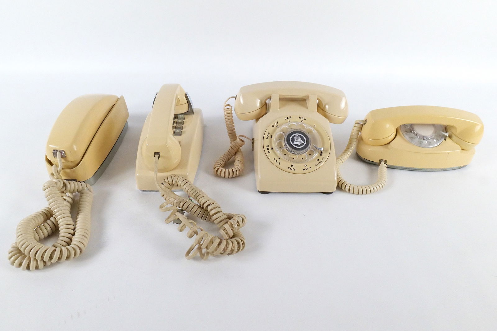 Lot of 4 Vintage Telephones: Lot of 4 Vintage Telephones. Including AT&T Rotary Princess Style Phone, Bell System Western Electric Rotary Desk Phone, AT&T Wall Hanging Phone, and Western Electric Wall Hanging Trimline Style Telep