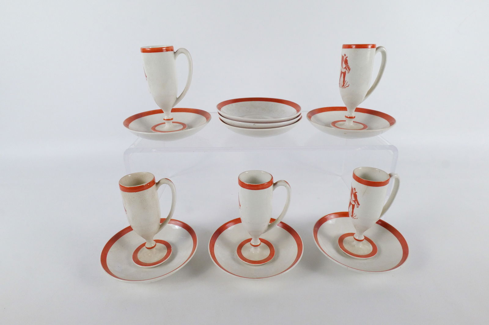 Antique Demitasse Devil Pottery Set: Antique Demitasse Devil Pottery Set. Including 5 Cups with Devil Images and 8 Saucers. One cup has been repaired at the base. There are some tiny chips on the base rims. Some craze present. Cups