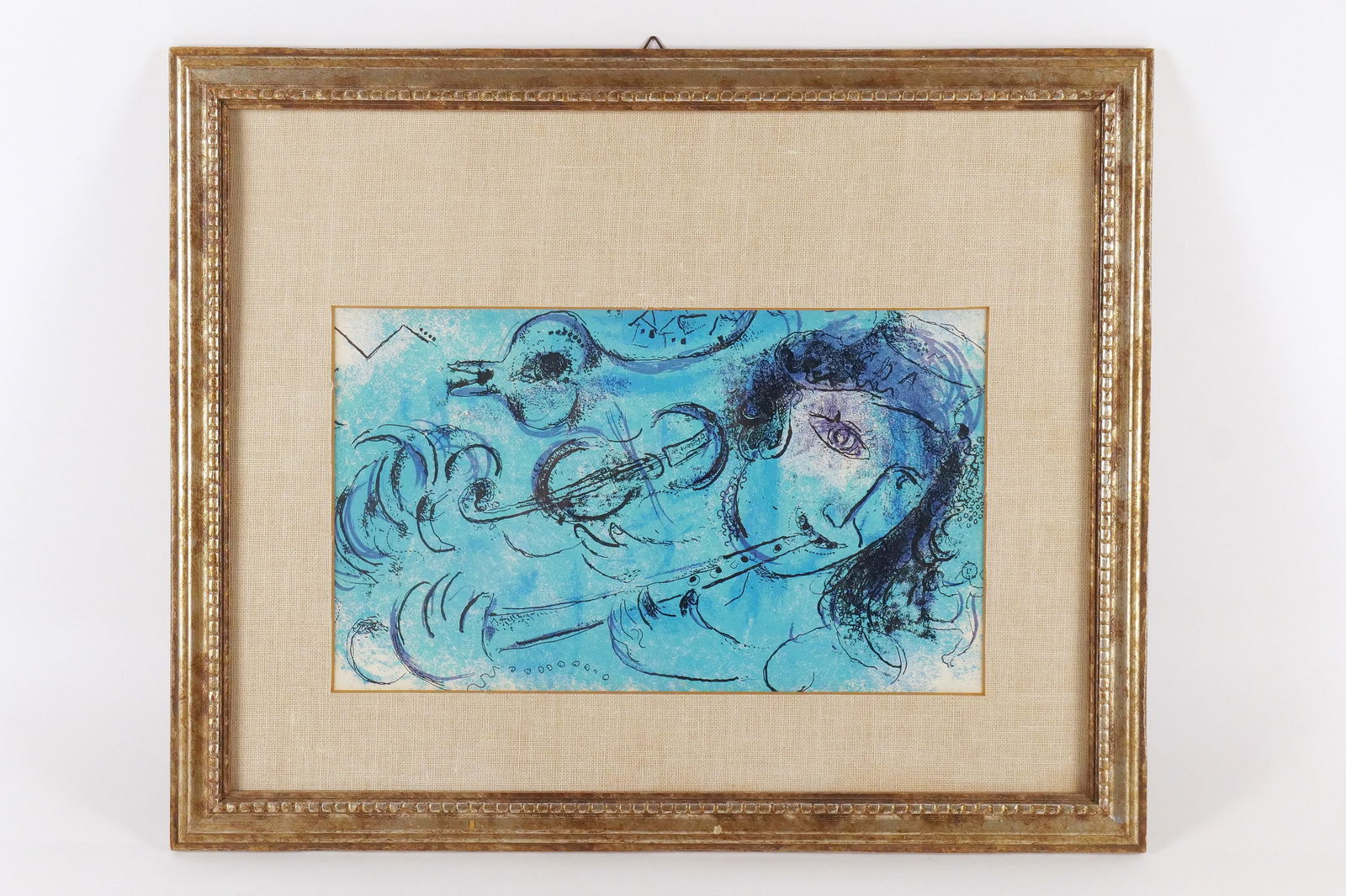 Framed Colored Lithograph by Marc Chagall: Framed Colored Lithograph by Marc Chagall. Entitled "Flute Player". Measures 18.5" tall x 22.5" wide. All invoices must be paid within 24 hours of the sale. We offer multiple shipping options, please