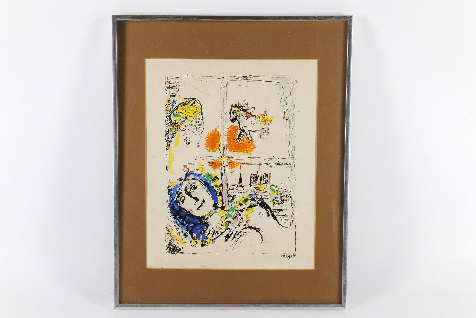 Framed Seriograph in Color by Marc Chagall: Framed Seriograph in Color by Marc Chagall. Entitled "Paris de la Fenetre". Glass could use a cleaning on the underside. Measures 20.5" tall x 16.5" wide. All invoices must be paid within 24 hours of