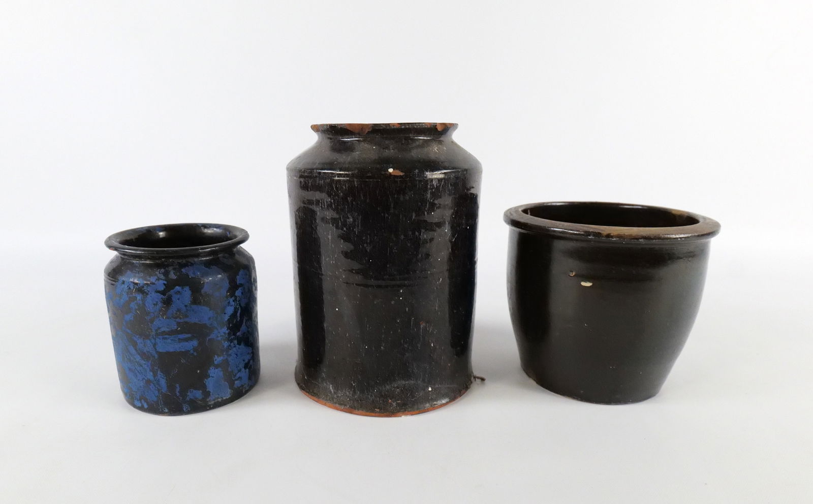 Lot of Antique Crocks: Lot of Antique Crocks. Including one with Blue and Black Sponge Decoration - Possibly added at a later date. All have some chipping to the rims and bases. Largest measures 8.5" x 6.5" wide. All invoic