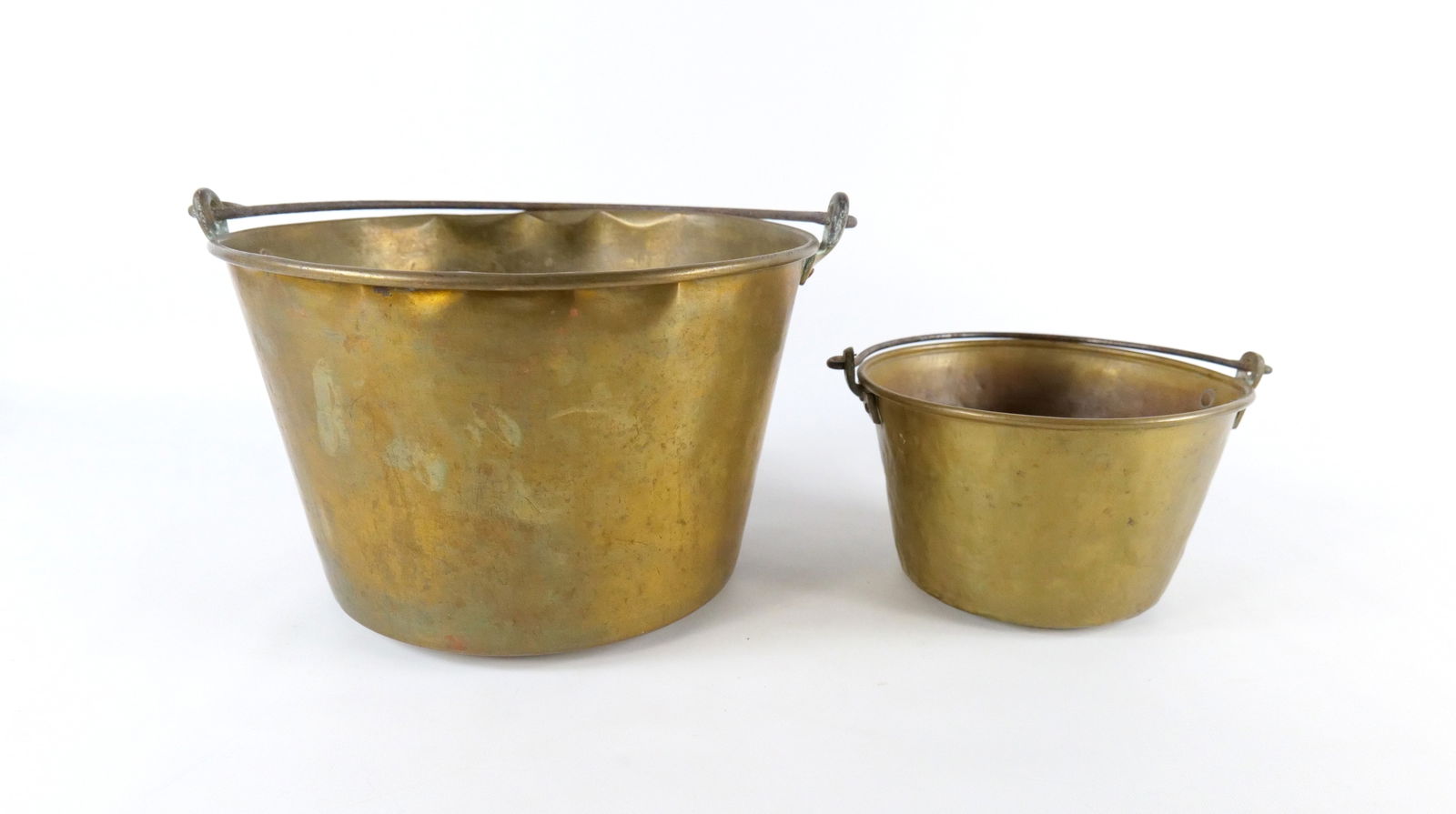 Lot of 2 Antique Brass Buckets: Lot of 2 Antique Brass Buckets. Some minor denting, Largest measures 9.25" tall x 15" wide when handle is down. All invoices must be paid within 24 hours of the sale. We offer multiple shipping option