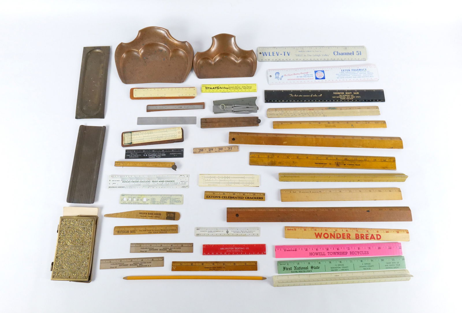 Lot of Desk Items: Lot of Desk Items. Including Art Nouveau Catchalls, Pen and Pencil Rests, Brass Hinged Notebook, and Various Rulers. All invoices must be paid within 24 hours of the sale. We offer multiple shipping o