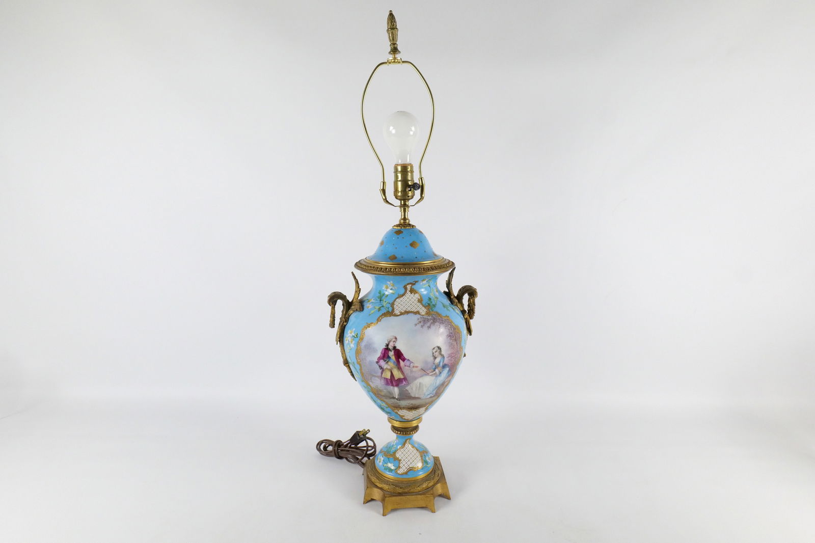 Antique Hand Painted Urn Lamp: Antique Hand Painted Urn Lamp. Has bronze mounts. Depicting courting scene. Most likely Limoges. Artist Signed. Measures 32" tall x 10.5" wide. All invoices must be paid within 24 hours of the sale. W