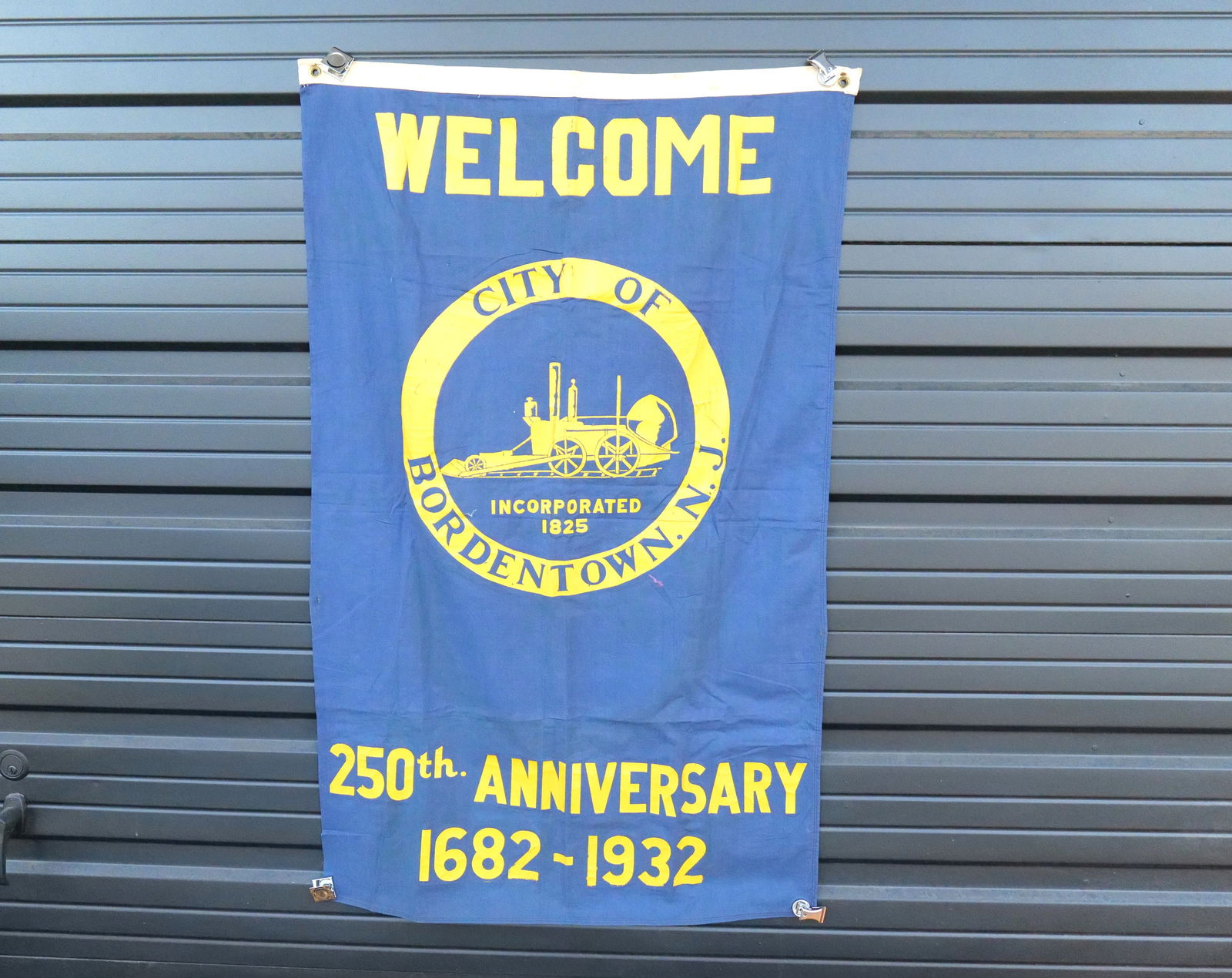 City of Bordentown NJ 250th Anniversary Flag: City of Bordentown NJ 250th Anniversary Flag. Dated 1682-1932. Some staining present. Some wear and holes present. Measures 47" long x 29" wide. All invoices must be paid within 24 hours of the sale.