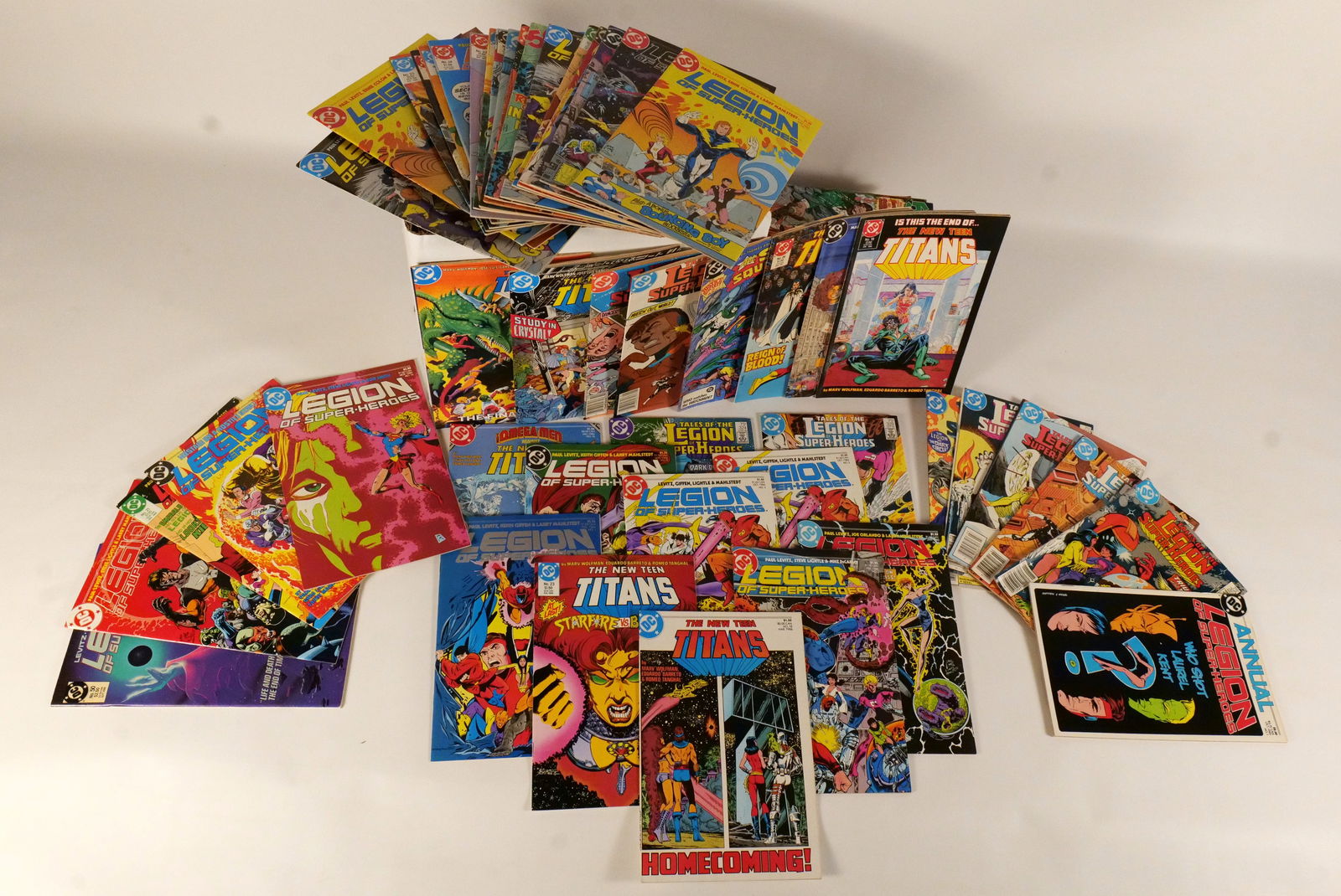 Short Box of DC "Team" Comics: Short Box of DC "Team" Comics. Including Infinity Inc., All Star Squadron, New Teen Titans, and Legion of Superheroes. Average Grade is VG to VF. Short Box is Full. Please note that the short boxes in