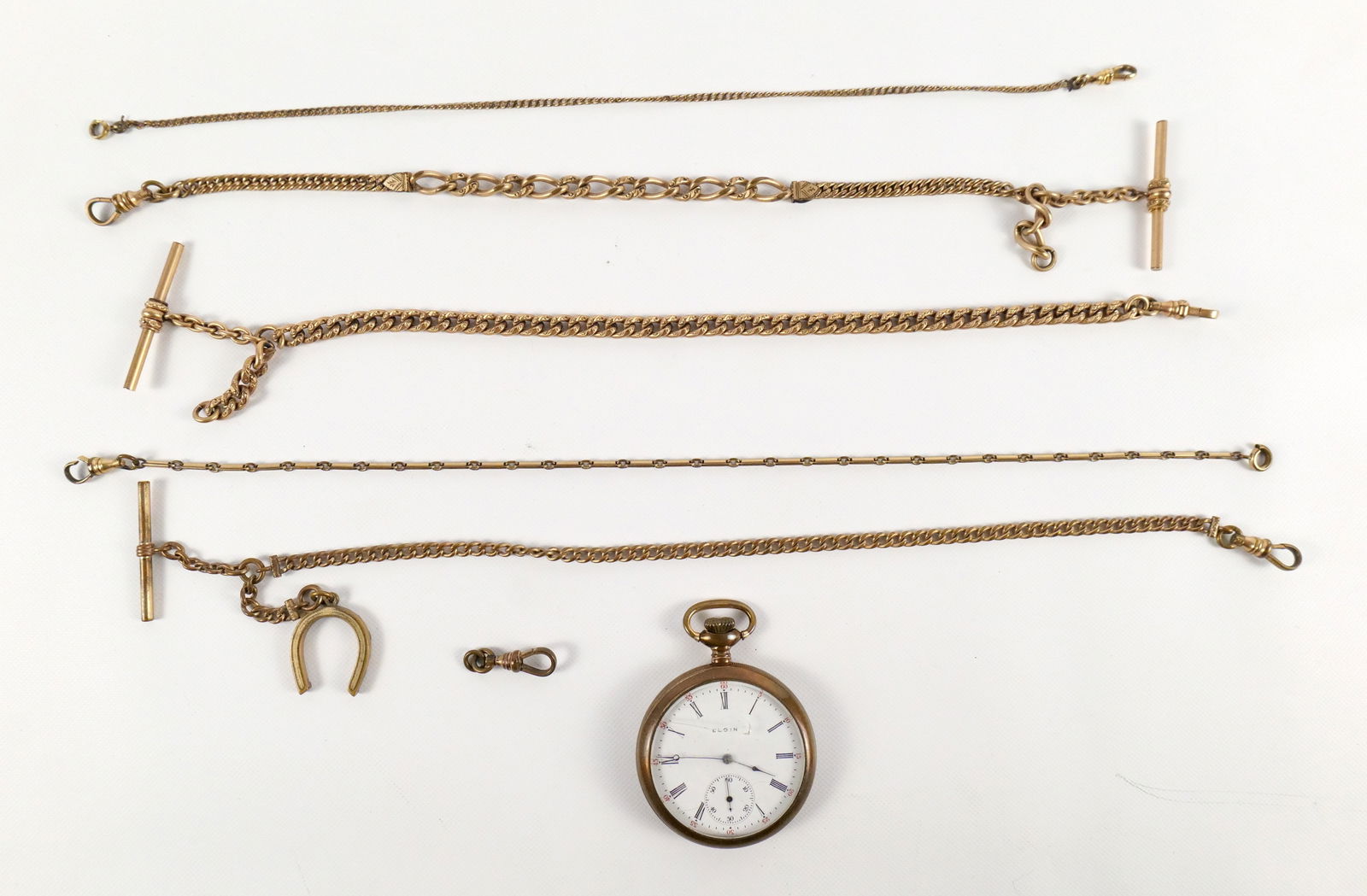 Lot of Watch Chains and Pocket Watch: Lot of Watch Chains and Pocket Watch. Pocket Watch is Elgin - Crystal is cracked measuring approx. 1 7/8". Watch Chains include One Marked FLS & Co, Watch Chain Marked FLS & Co. - Missing Chain, Possi