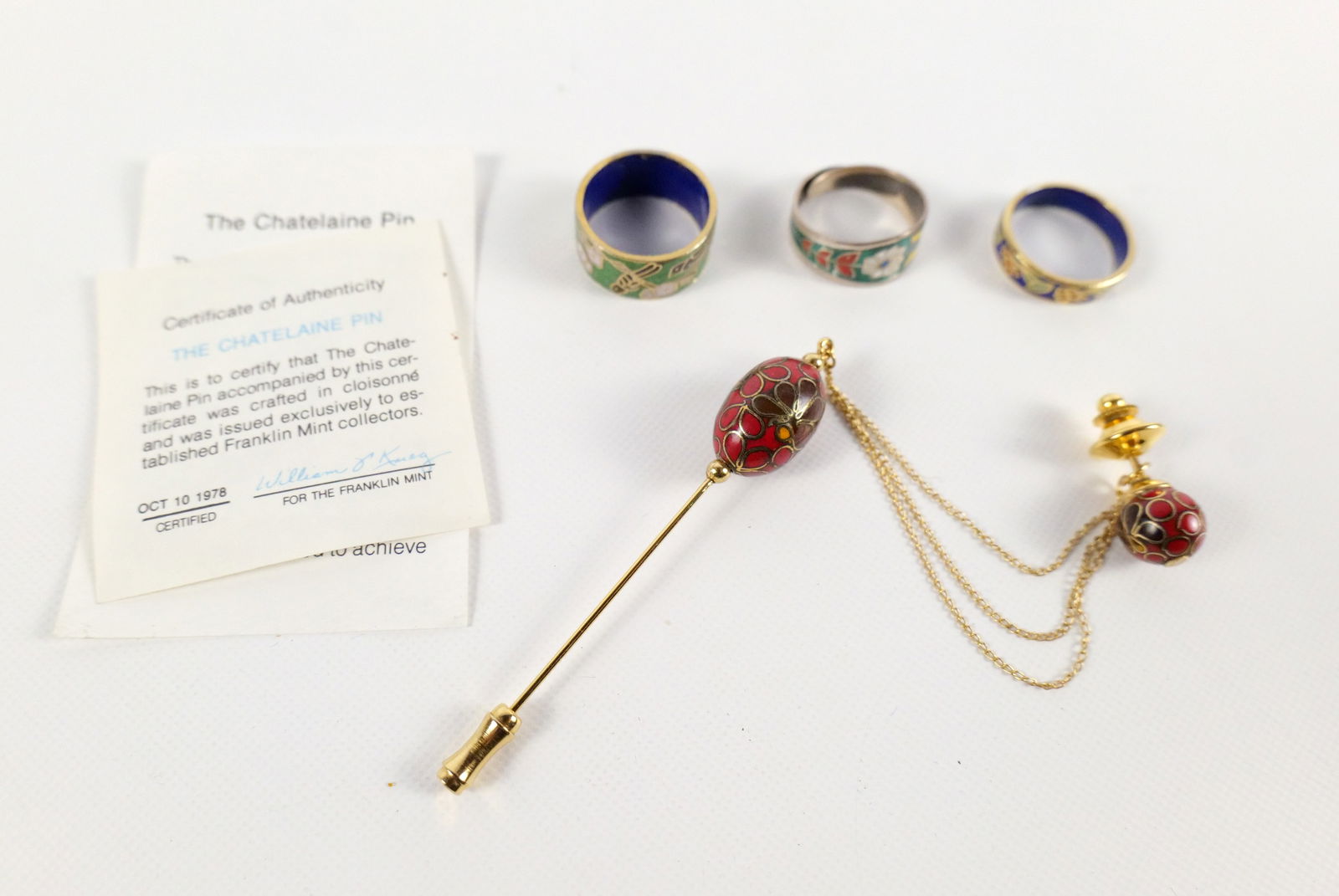Lot of Cloisonne Pieces: Lot of Cloisonne Pieces. Including The Franklin Mint Chatelaine Pin and 3 Rings. One ring is sterling with adjustable band. All invoices must be paid within 24 hours of the sale. We offer multiple shi