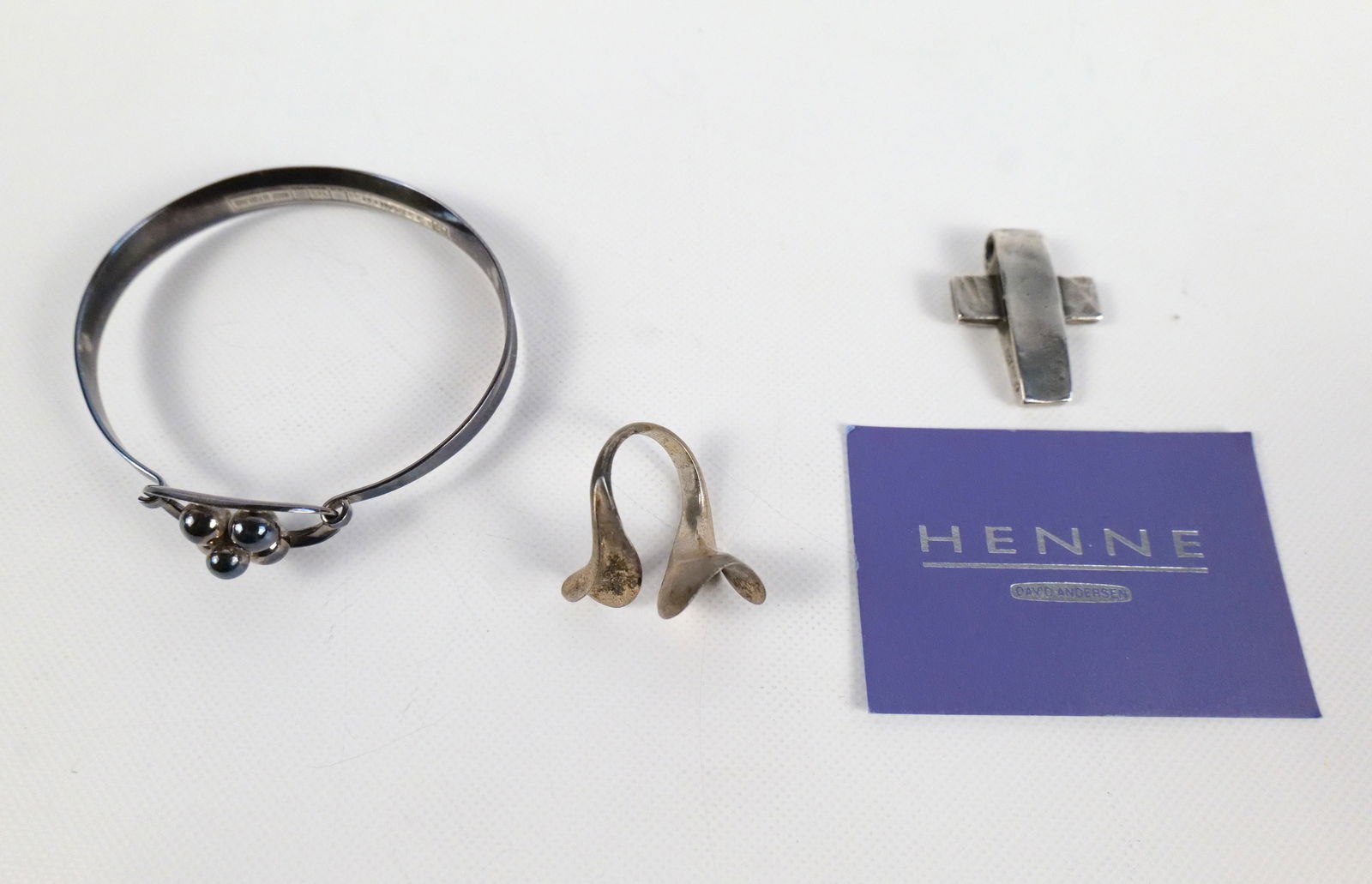 Lot of Sterling Silver Mid Century Modern Jewelry: Lot of Sterling Silver Mid Century Modern Jewelry. Including Bangle Bracelet - Marked E. Granite & Co Finland, Ring - Size 5, and Henne David Anderson Brutalist Cross Pendant measuring 1 1/8". All inv