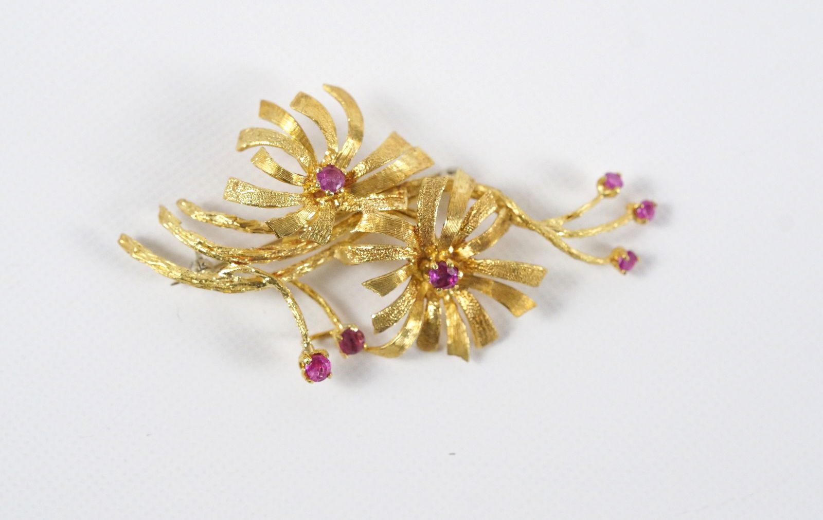 18k and Ruby Floral Spray Pin: 18k and Ruby Floral Spray Pin. Measures 2 3/8" long. Weighs 10.1 grams with stones. All invoices must be paid within 24 hours of the sale. We offer multiple shipping options, please read the shipping