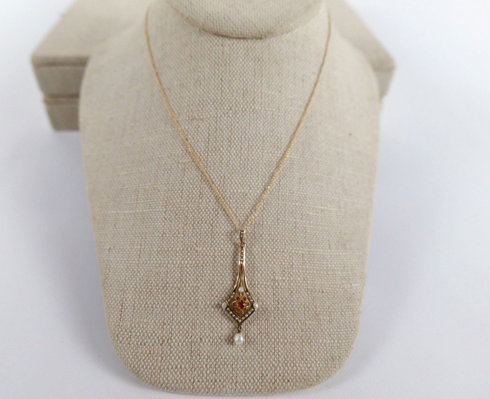 10k Gold Pendant with Red Stone and Seed Pearls: 10k Gold Pendant with Red Stone and Seed Pearls. Comes on Gold Filled Chain. Chain measures 15". Pendant measures 1 5/8" long. All invoices must be paid within 24 hours of the sale. We offer multiple