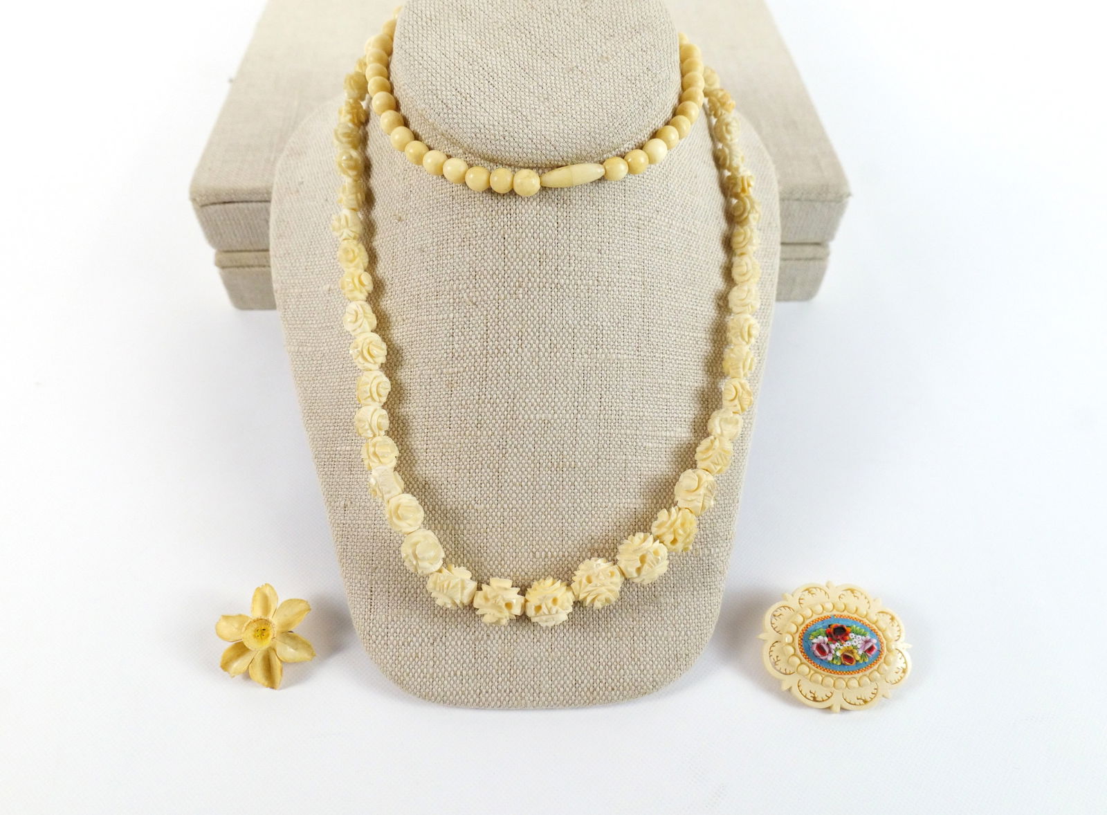 Lot of 3 Pieces of Carved Bone Jewelry: Lot of 3 Pieces of Carved Bone Jewelry. Including Micro Mosaic Pin, Bead Graduated Necklace, and Orchid Brooch. Necklace measures 30". All invoices must be paid within 24 hours of the sale. We offer m