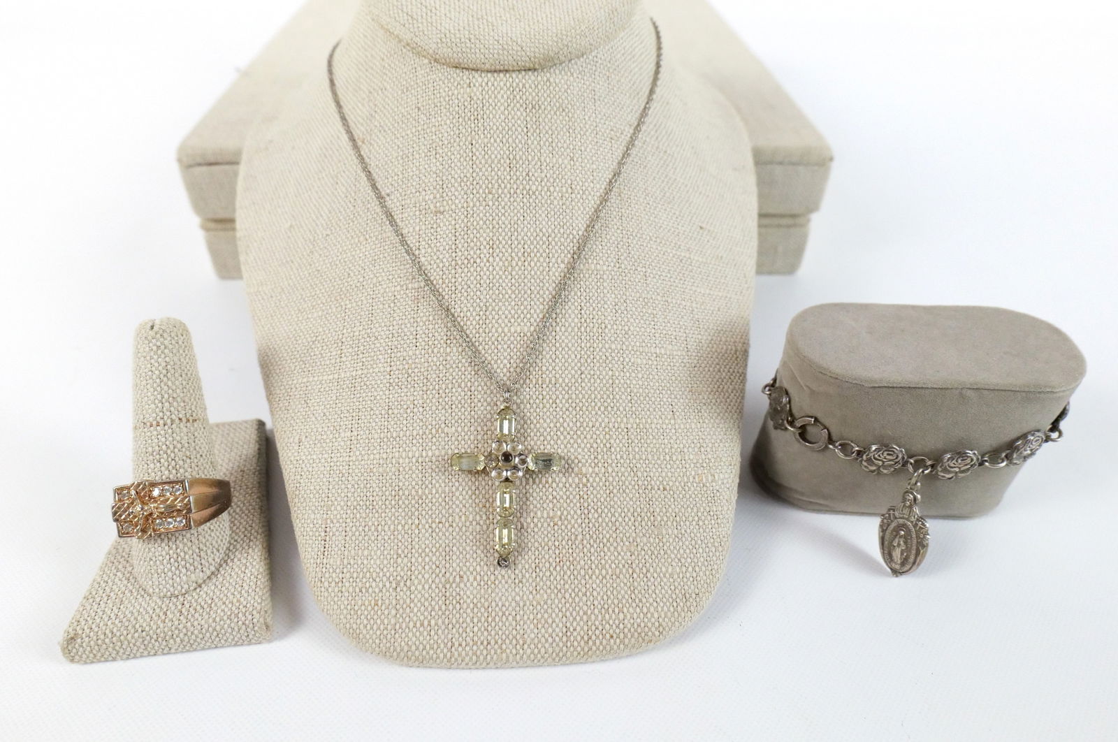 Lot of Sterling Silver Religious Jewelry: Lot of Sterling Silver Religious Jewelry. Including Men's Gold Vermil Crucifix Ring with Crystals - Size 11, Sterling and Rhinestone Cross with Prayer inside measuring 17", and Rose Link Bracelet with
