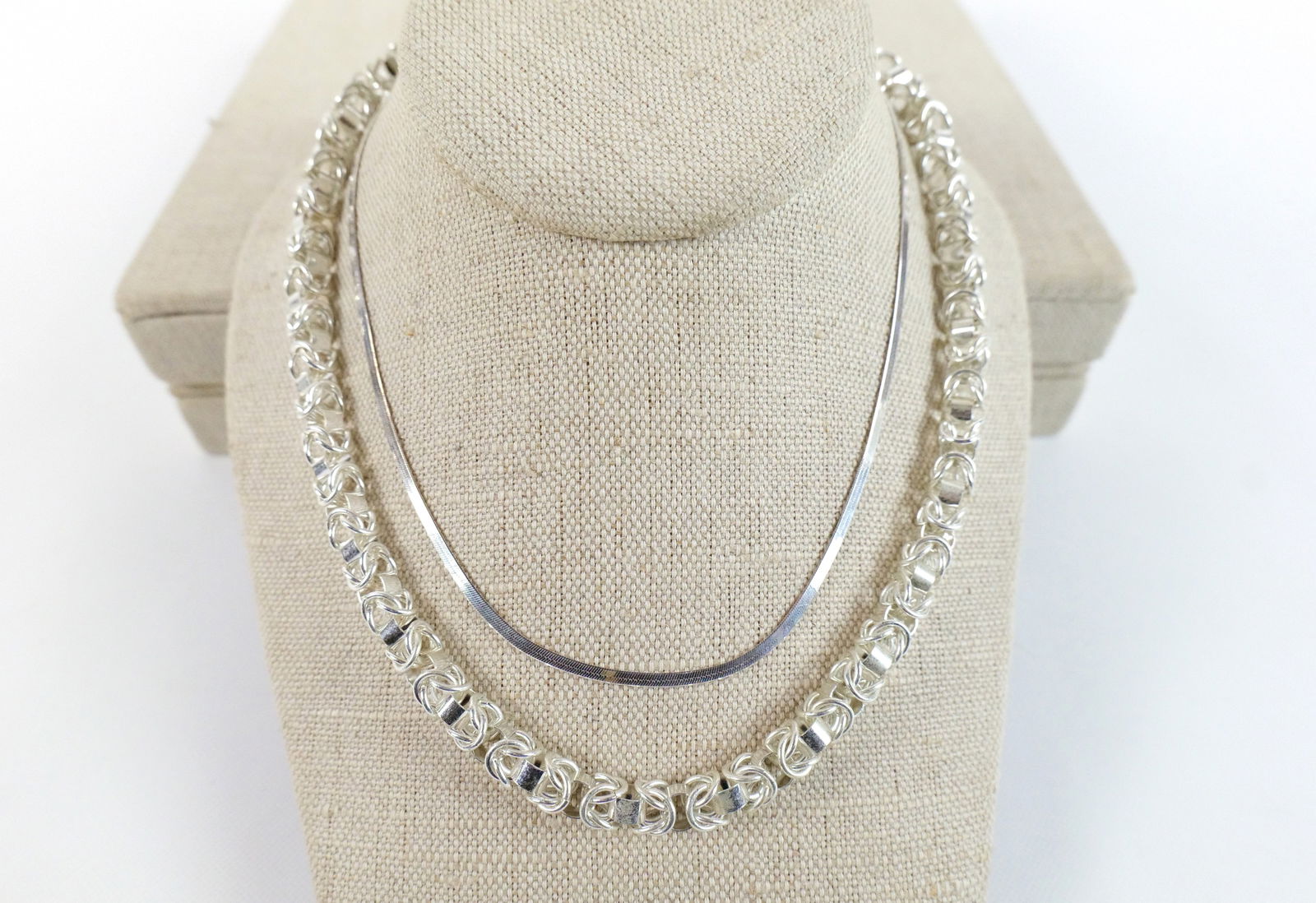 Lot of 2 Sterling Necklaces: Lot of 2 Sterling Necklaces. Including Box Chain weighing approx. 44.8 grams measuring 16" long and Herringbone Chain. All invoices must be paid within 24 hours of the sale. We offer multiple shipping