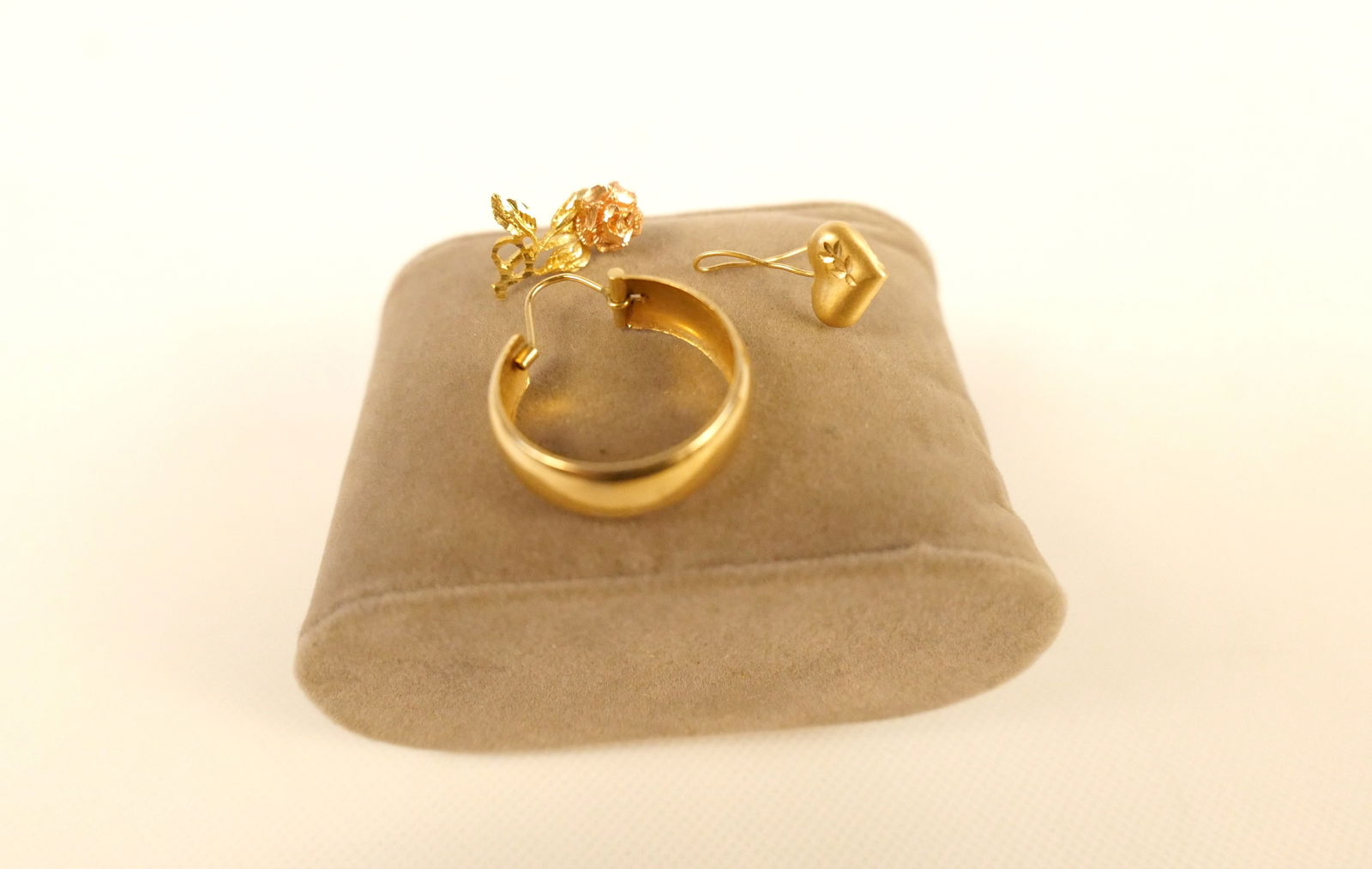 14k Scrap Lot: 14k Scrap Lot. Consists of Single Hoop Earring, Single Gold Floral Earring, and Single Heart Earring with Bent Post. Weighs approx. 3.2 grams. All invoices must be paid within 24 hours of the sale. We