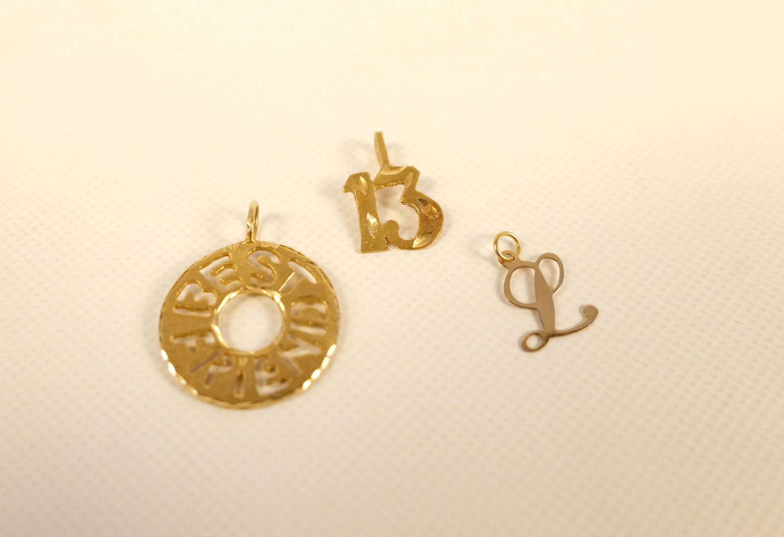 Lot of 3 14k Gold Pendants: Lot of 3 14k Gold Pendants. Including 13, Letter L, and Best Friends. Weighs approx. 1.7 grams. All invoices must be paid within 24 hours of the sale. We offer multiple shipping options, please read t