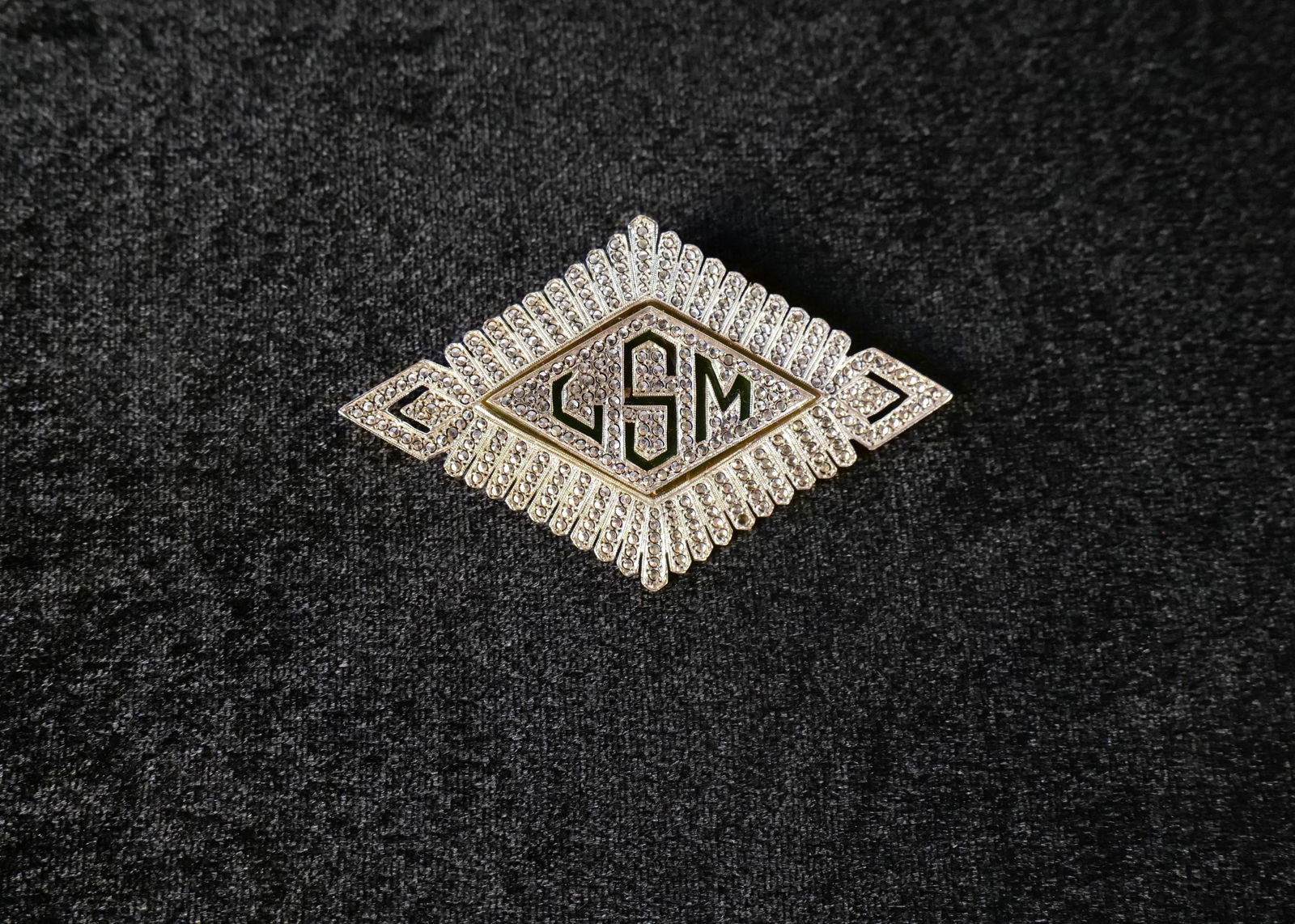 Sterling Silver and Marcasite Deco Monogrammed Pin: Sterling Silver and Marcasite Deco Monogrammed Pin. Initials L.M.S. Measures approx. 2 3/8" across. Missing some stones. All invoices must be paid within 24 hours of the sale. We offer multiple shippi