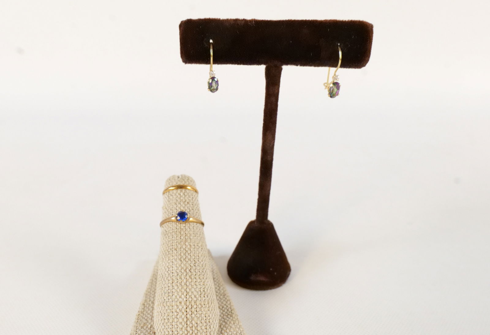 Lot of 10k Jewelry: Lot of 10k Jewelry. Including Ring with Blue Stone - Size 5, Child Band - Size 2, and Pair of Drop Earrings - Set with Gemstones. All invoices must be paid within 24 hours of the sale. We offer multip