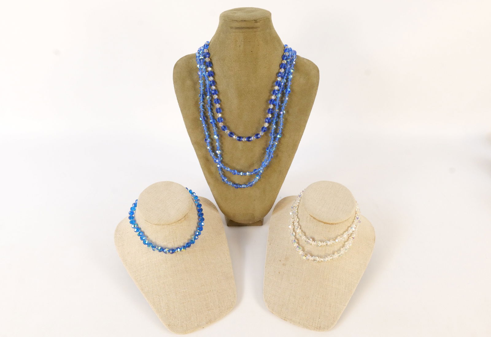 Lot of Blue and Clear Faceted Crystal Necklaces: Lot of Blue and Clear Faceted Crystal Necklaces. Some fleabite chips to crystals. Longest measures 26". All invoices must be paid within 24 hours of the sale. We offer multiple shipping options, pleas