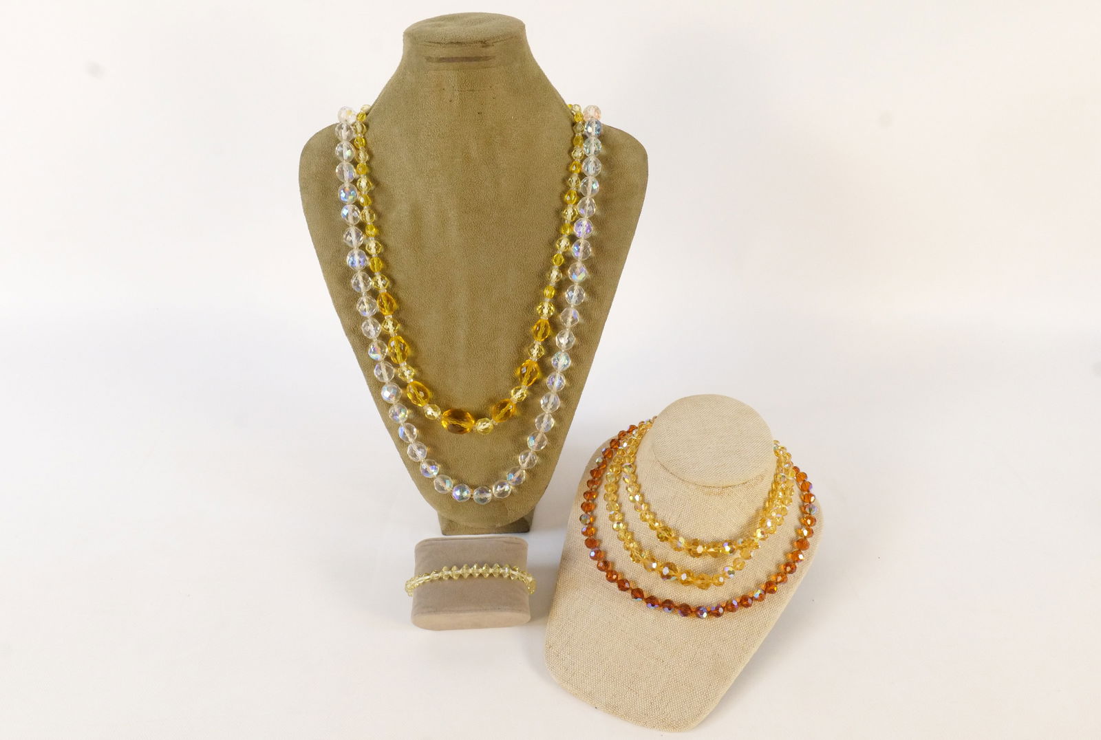 Lot of Faceted Crystal Jewelry: Lot of Faceted Crystal Jewelry. Some fleabite chips to crystals. Including Amber, Yellow, and AB. Longest measures 31". All invoices must be paid within 24 hours of the sale. We offer multiple shippin