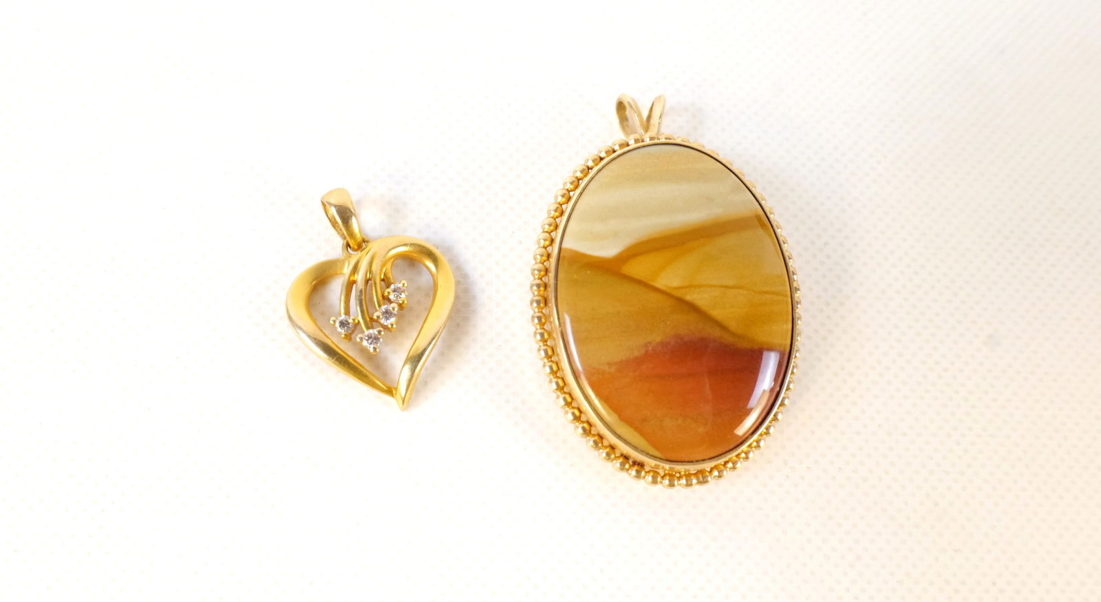 Lot of 14k Gold Jewelry: Lot of 14k Gold Jewelry. Including Heart Pendant Set with 4 Diamonds and Jasper Stone Pendant measuring 1 3/8". All invoices must be paid within 24 hours of the sale. We offer multiple shipping option