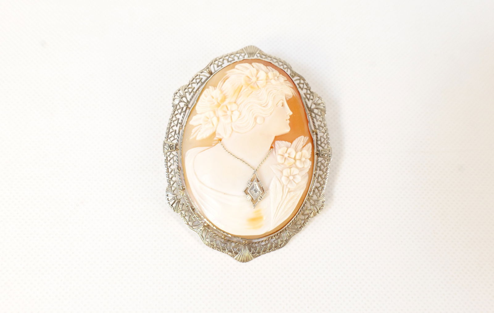 10k White Gold Pendant/Cameo Brooch: 10k White Gold Pendant/Cameo Brooch with Diamond. Measures 2.25" long. All invoices must be paid within 24 hours of the sale. We offer multiple shipping options, please read the shipping terms to unde