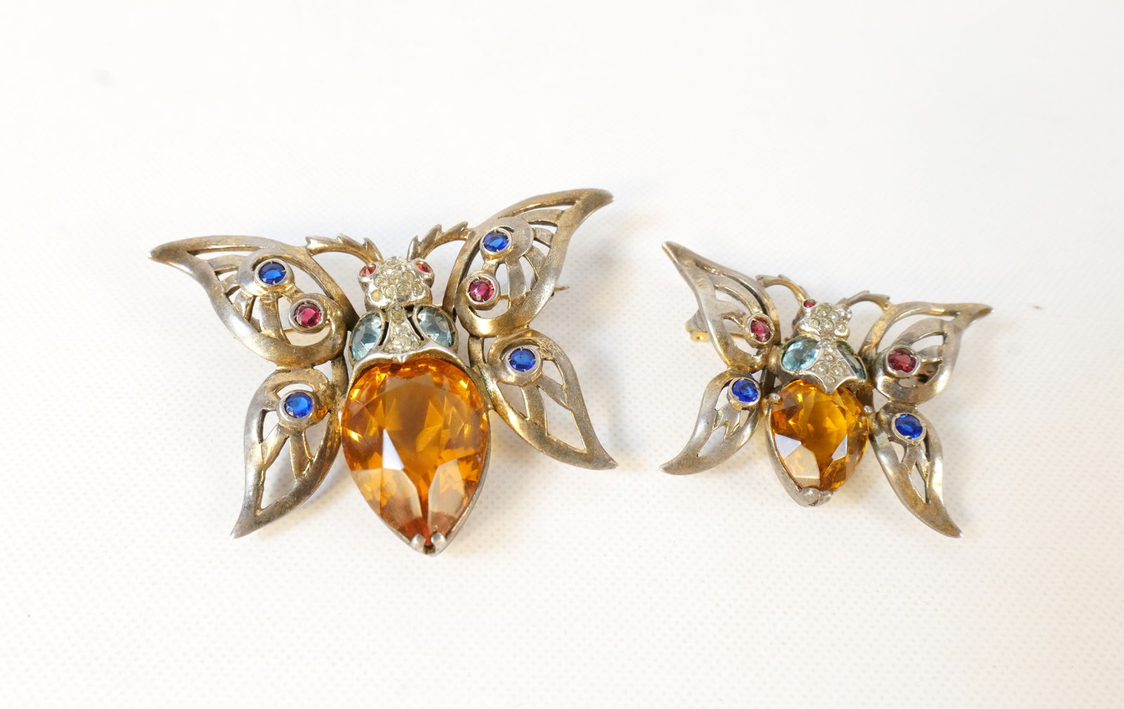 Lot of 2 Vintage Reja Sterling Silver Vermil Butterfly Pins: Lot of 2 Vintage Reja Sterling Silver Vermil Butterfly Pins. Including Amber, Blue, and Pink Crystals. Largest measures 2.5". Smallest is missing a stone from the eye. All invoices must be paid within