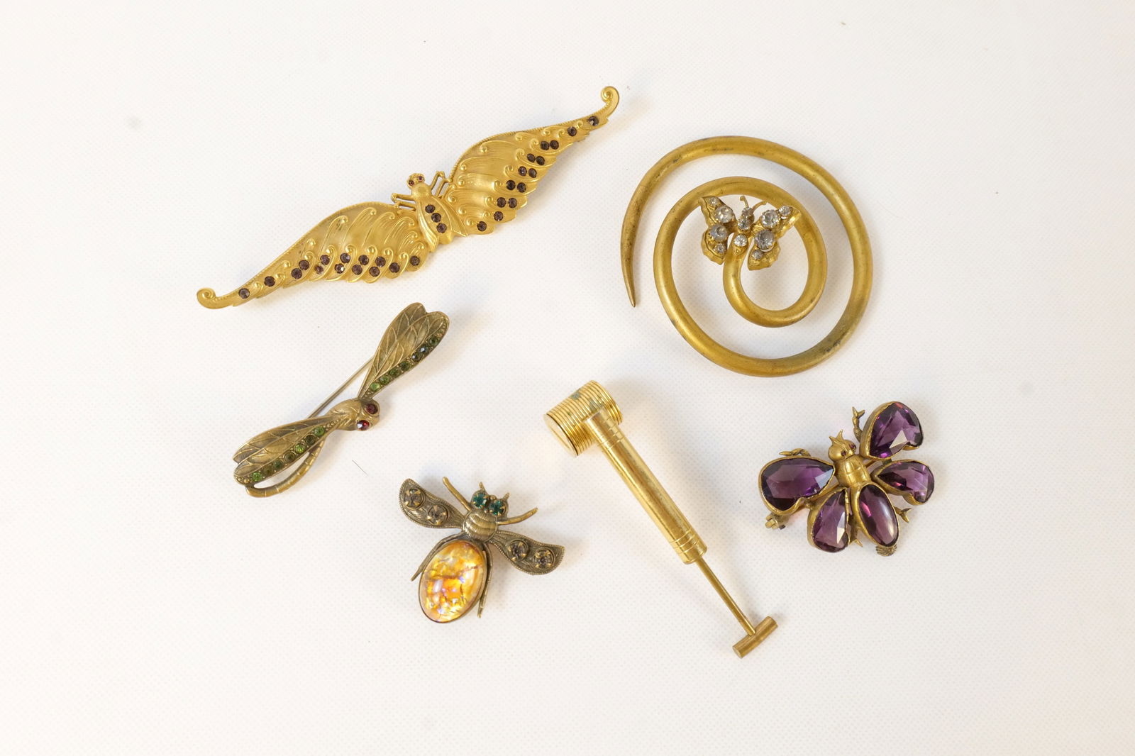 Lot of Assorted Vintage Jewelry and Vanity: Lot of Assorted Vintage Jewelry and Vanity. Including Art Nouveau GLR Matte Butterfly Brooch with Purple Crystals, Mini Brass Perfume Atomizer Pump, Gold Tone and Crystal Butterfly Spiral Hair Accesso