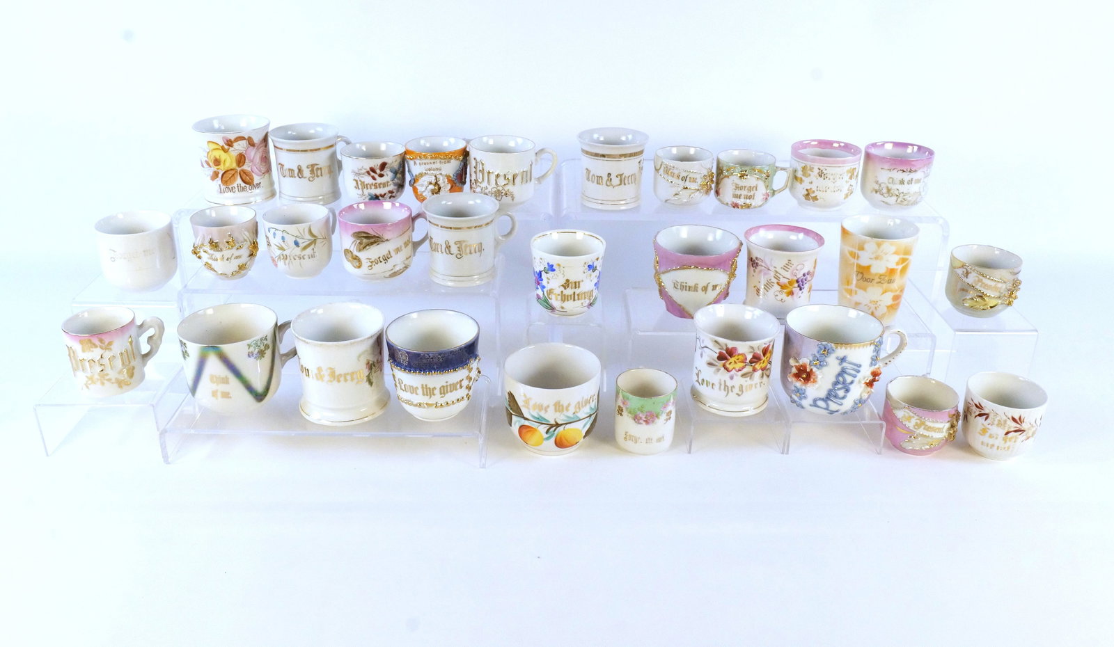 Lot of 25+ Souvenir Cups: Lot of 25+ Souvenir Cups. Victorian Era - 1950's. Including Present, Tom and Jerry, A Present from Ireland, Think of Me, Love the Giver, Forget Me Not, and More. Tallest measures approx. 3.25". Some c