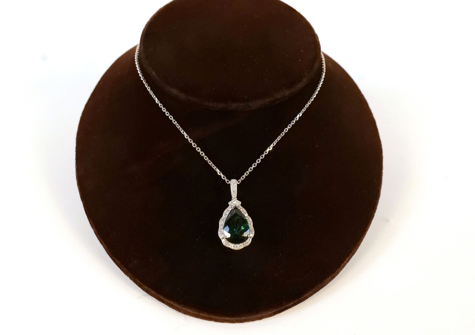 Platinum Tourmaline and Diamond Pendant with Chain: Platinum Tourmaline and Diamond Pendant with Chain. The Tourmaline weighs approx. 8.15 carats. Diamond weight is approx. .49 carats. Total weight is 12.3 grams. Chain measures 17" long. Comes with a G