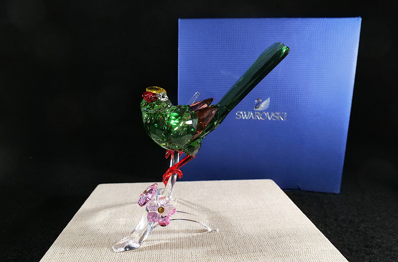 Swarovski Crystal Green Magpie Figurine: Swarovski Crystal Paradise Birds Green Magpie. Crystal Colors are Green, Yellow, Red, Pink and Clear. Measures approx. 6.5" tall. Comes with original box. All invoices must be paid within 24 hours of