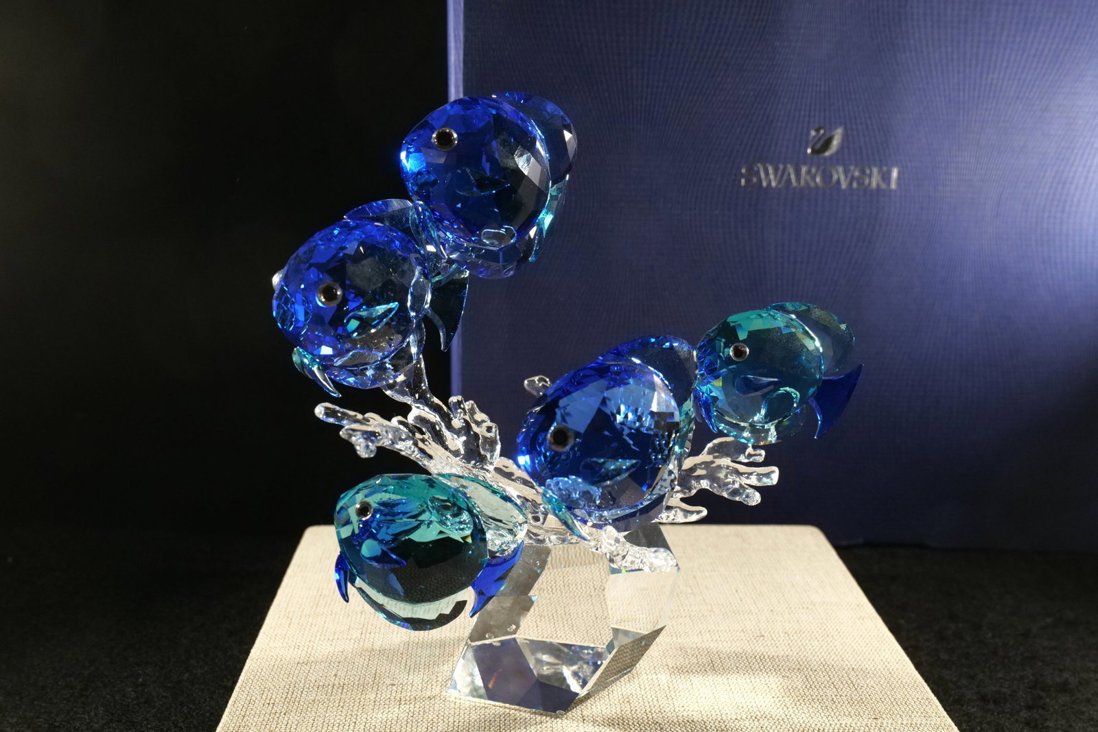 Swarovski School of Fish Figurine: Swarovski School of Fish Figurine. Features various shades of blue fish with clear crystal coral. Measures approx. 7.5" tall x 7.5" long. Comes with box. All invoices must be paid within 24 hours of t