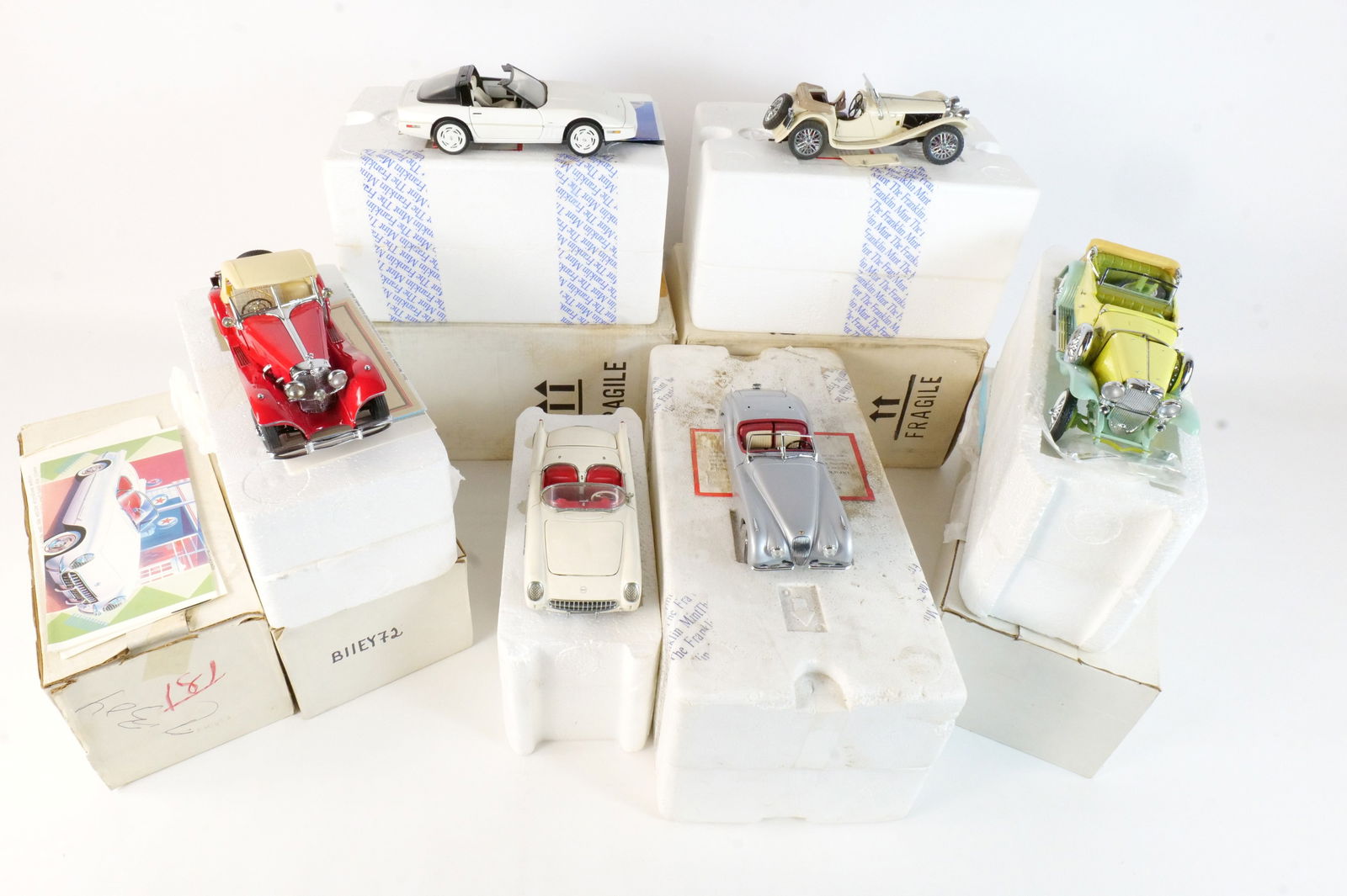 Lot of 6 Franklin Mint Diecast Cars 1:24 Scale: Lot of 6 Franklin Mint Diecast Cars 1:24 Scale. Lot includes An Off-white 1953 Corvette, An Off-white 1938 Jaguar SS100, A Yellow and Turquoise 1930 Duesenberg J Derham TourIster, A Silver 1952 Jaguar