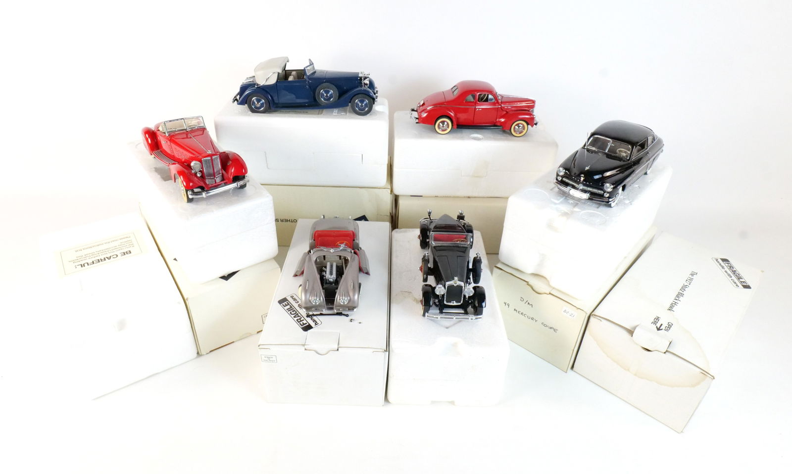 Lot of 6 Danbury Mint Diecast Cars 1:24 Scale: Lot of 6 Danbury Mint Diecast Cars 1:24 Scale. Lot includes A Black 1927 Stutz Black Hawk, A Red 1940 Ford Deluxe Coupe, A Red 1934 Packard V-12 Lebaron Speedster, A Silver 1949 Jaguar XK120, A Blue 1